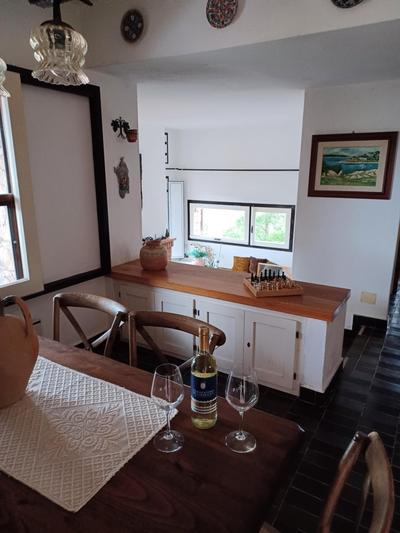 Villa La Lecceta surrounded by greenery and sea view with sunset