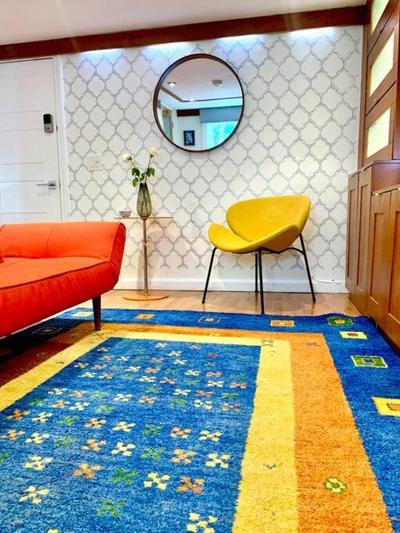 Live in this iconic East Side lower level unit