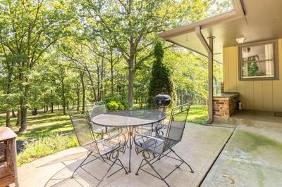 Home on the hill, nestled in the woods.