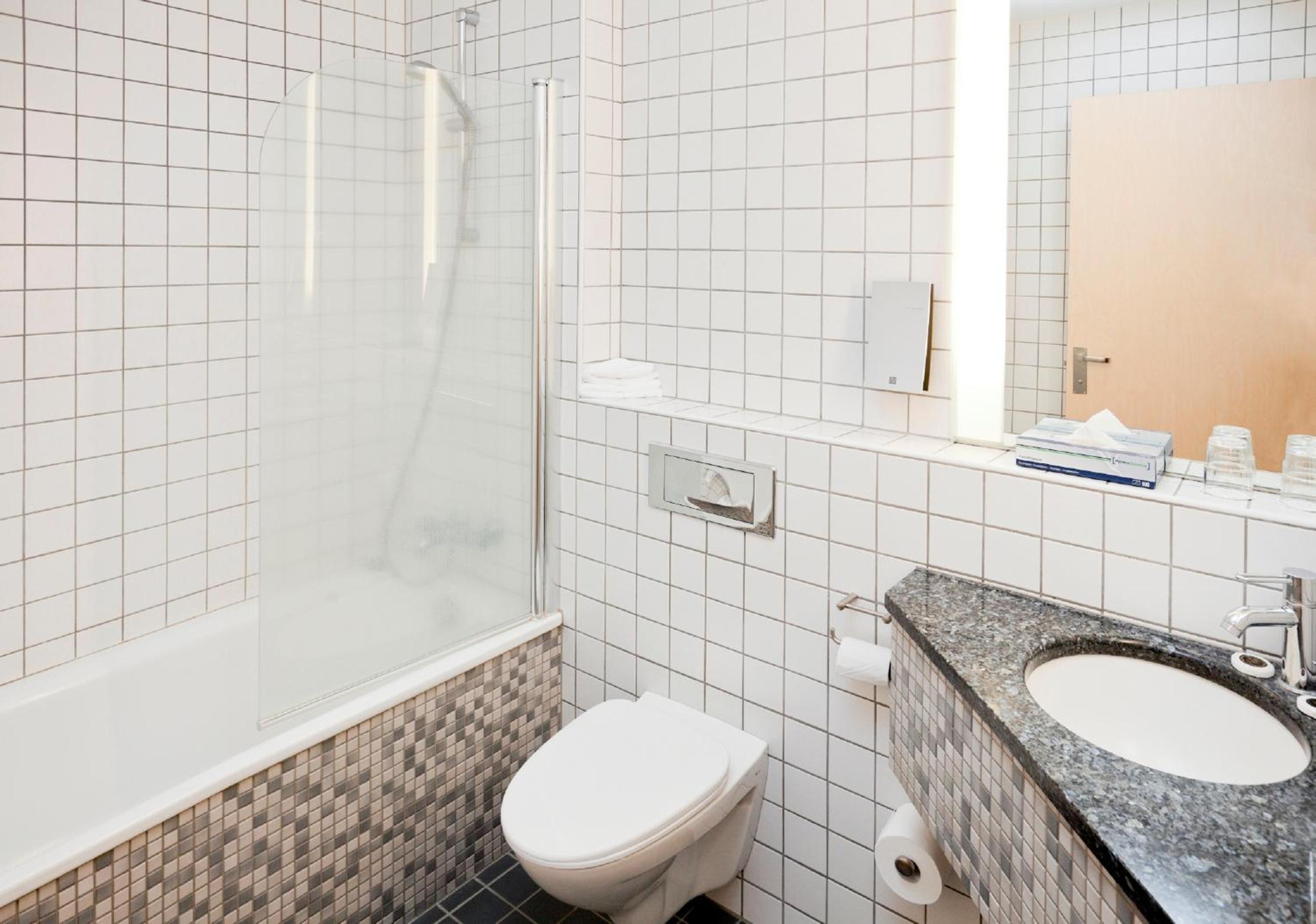 Relax in our elegantly designed bathroom retreat.