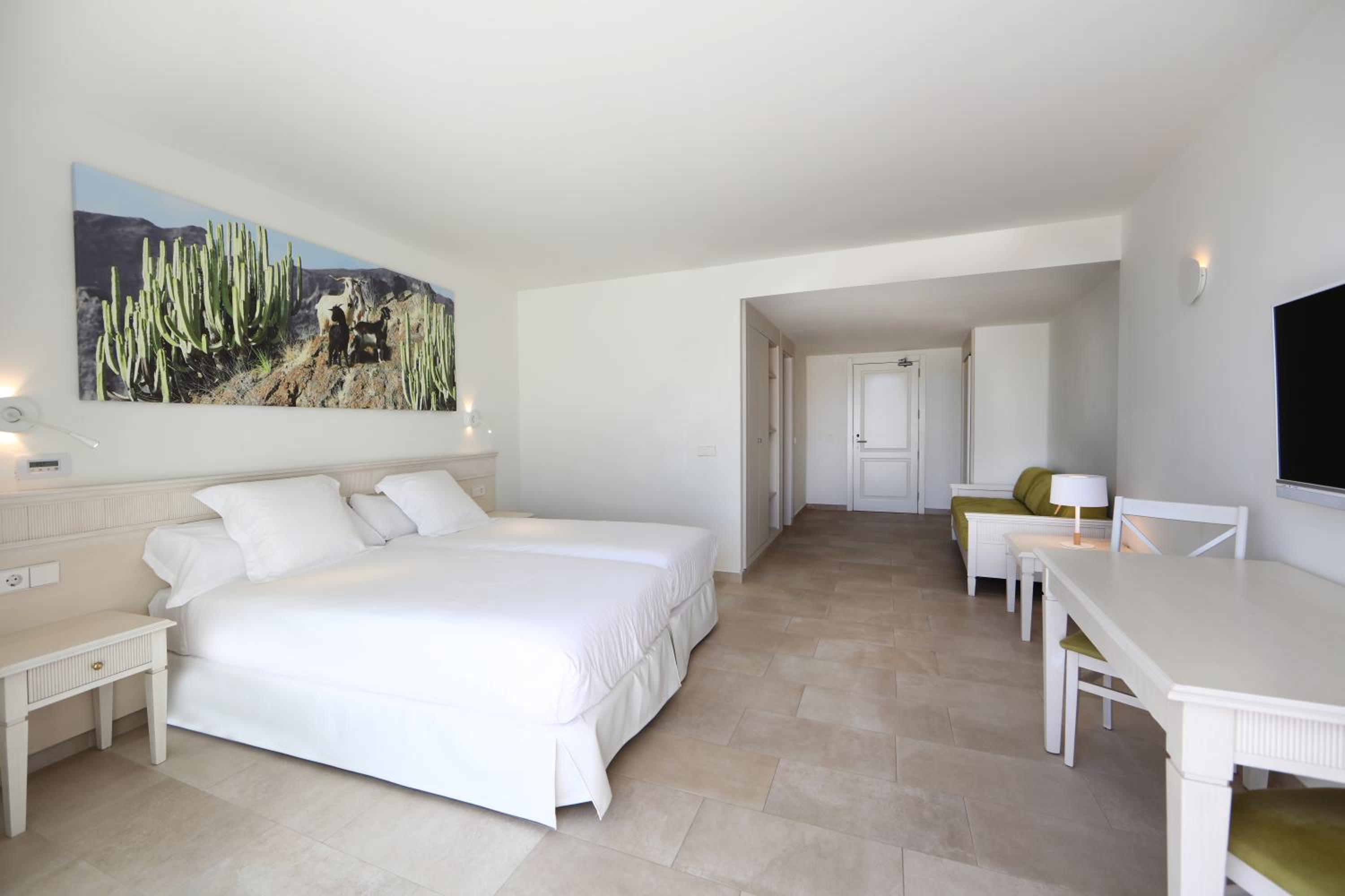 hotel room with two beds and a flat screen tv