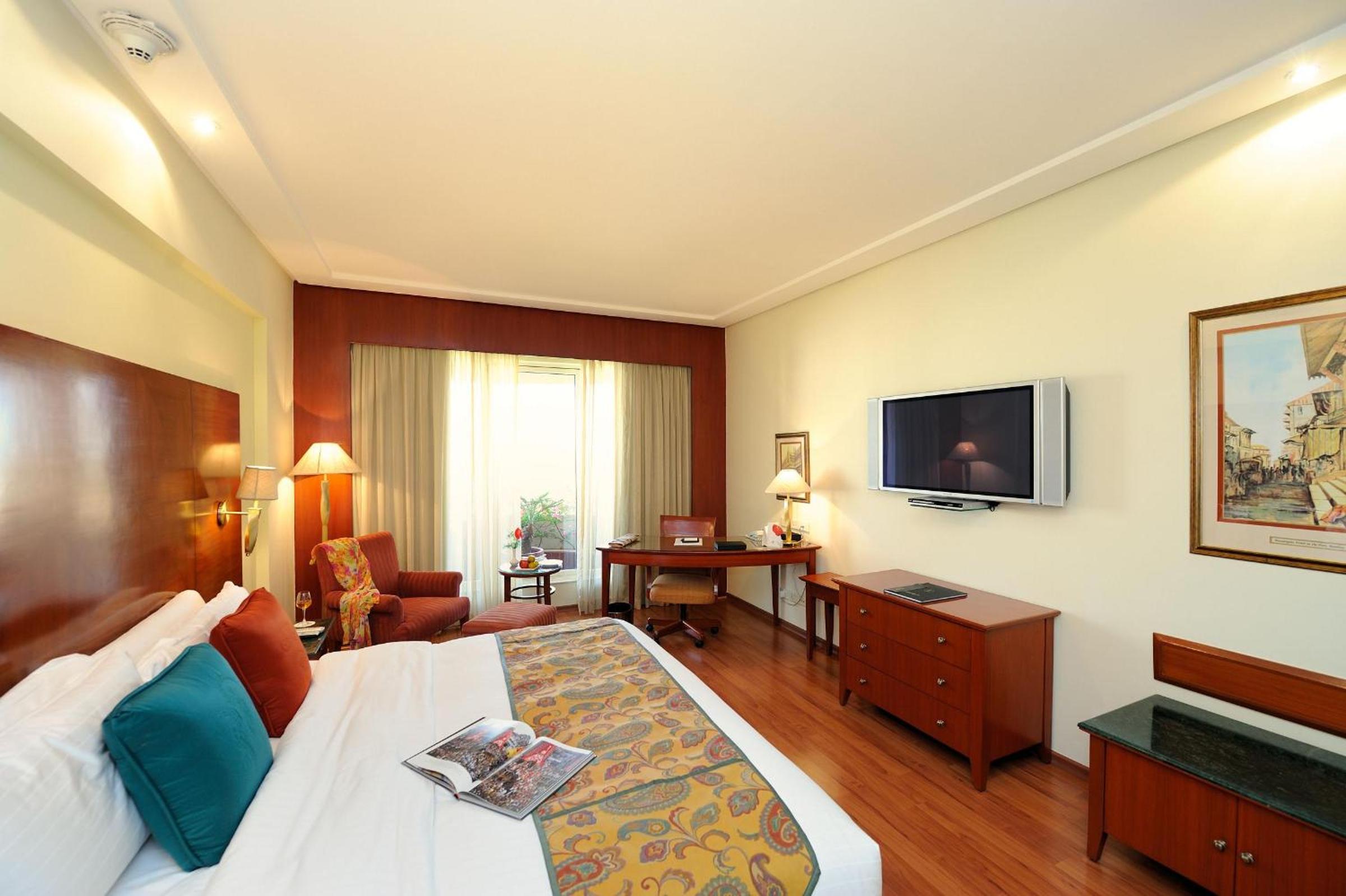 Lalit Luxury Suite, King Bed with Complimentary One way Airport Transfers , 15% off on session on Spa and Enjoy Happy Hours with 1+1 offer on Beverages