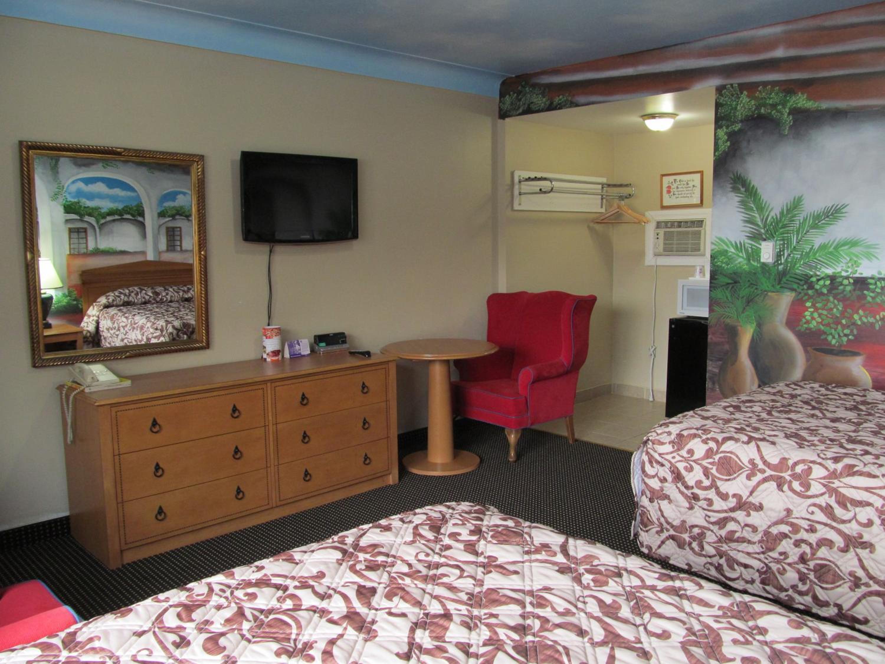 hotel room with two beds and a flat screen tv