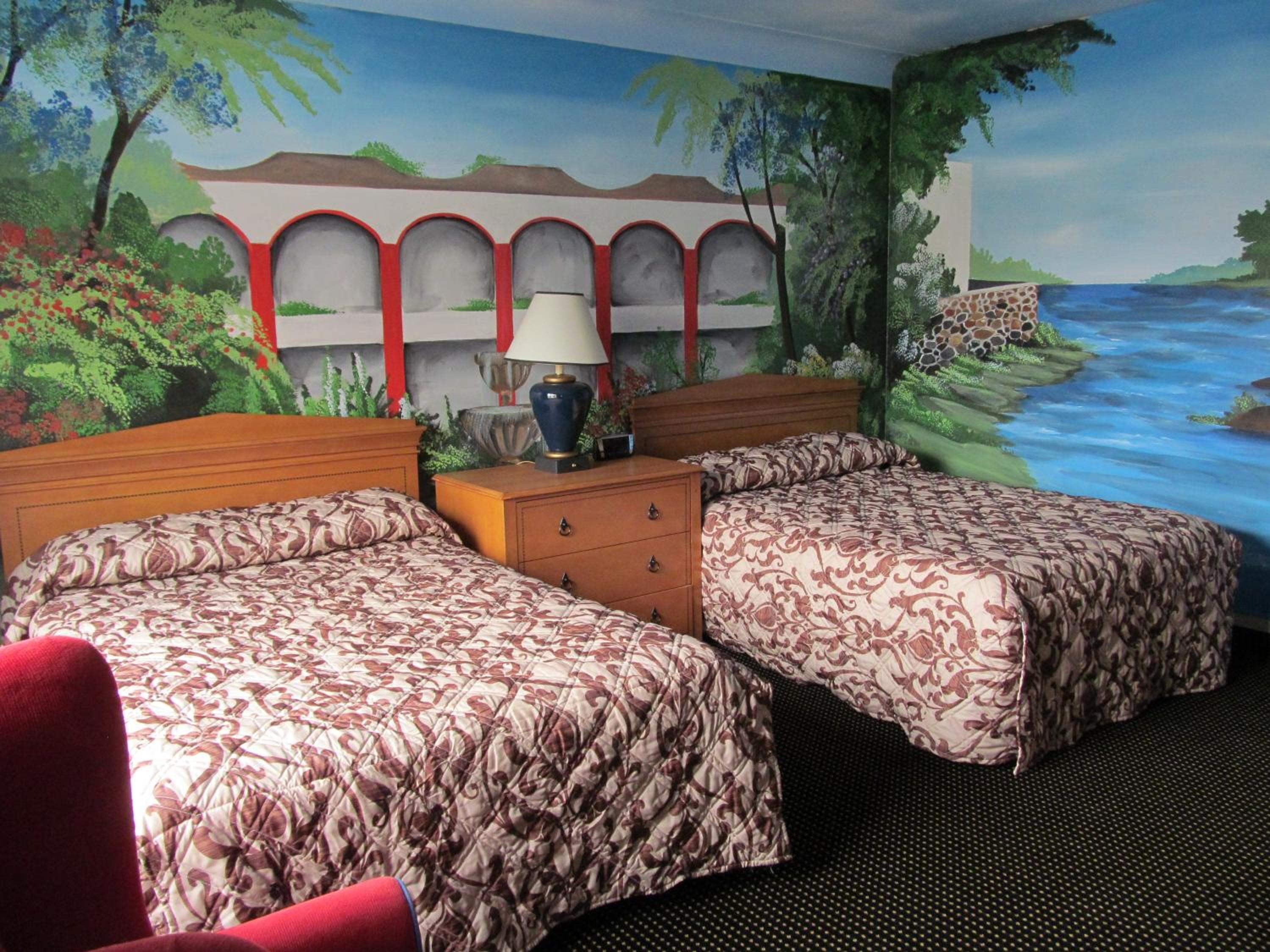 room with two beds and a painting on the wall