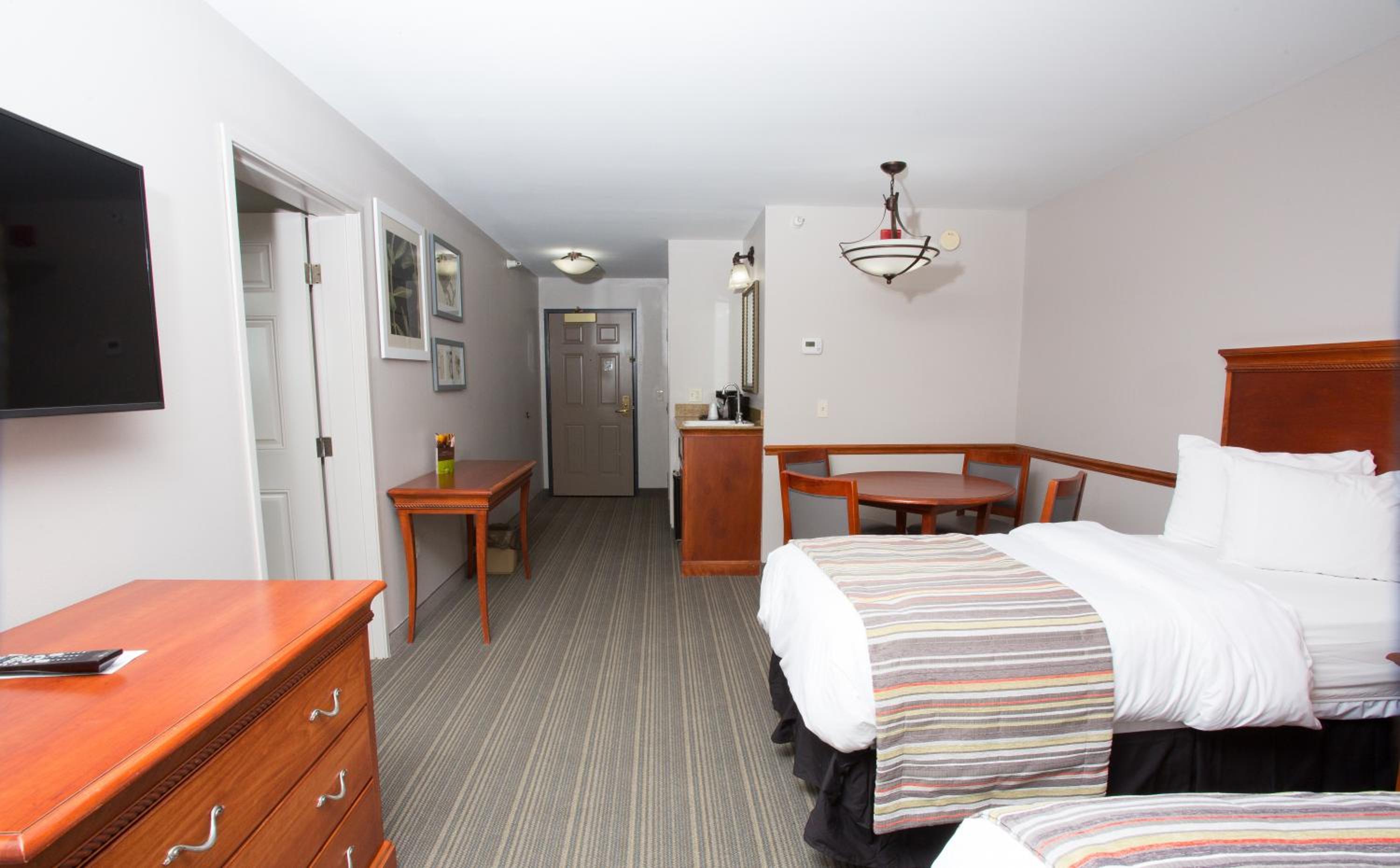 Extended Stay King Suite with One King bed and Two Single Beds - Non-Smoking - Photo 1