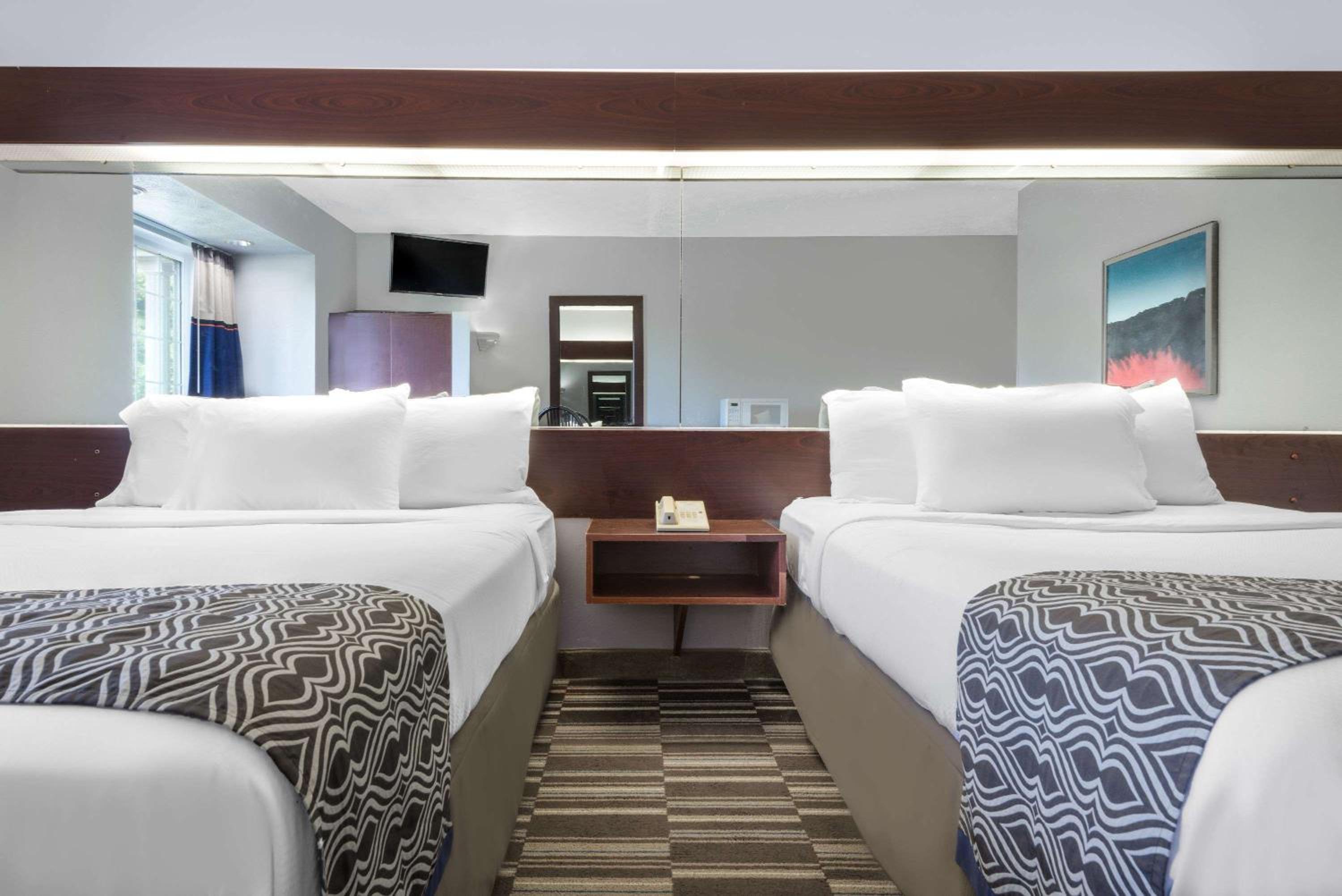 hotel room with two beds and a flat screen tv