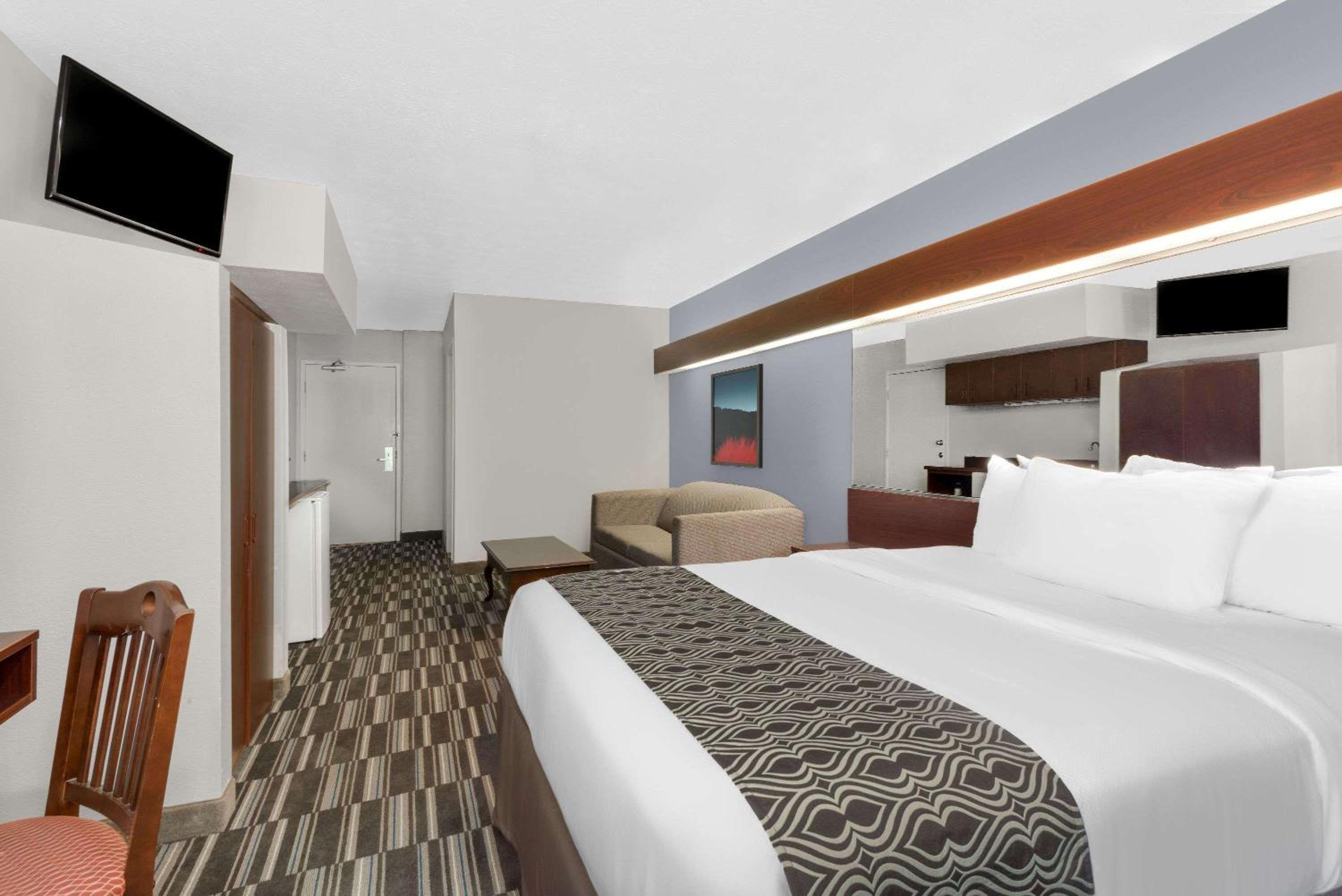 hotel room with a king size bed and flat screen tv