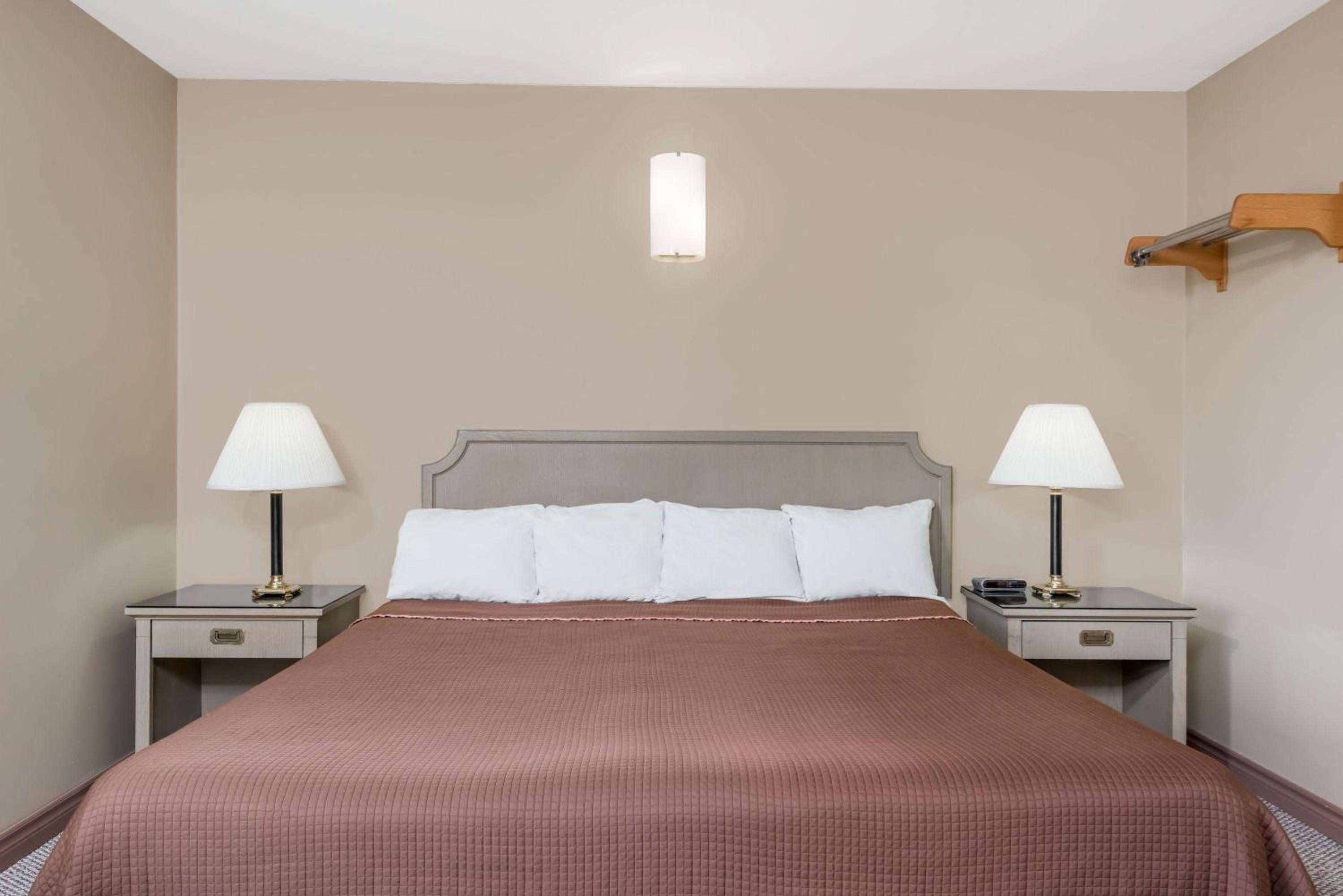 bedroom with a bed and two lamps on either side of the bed