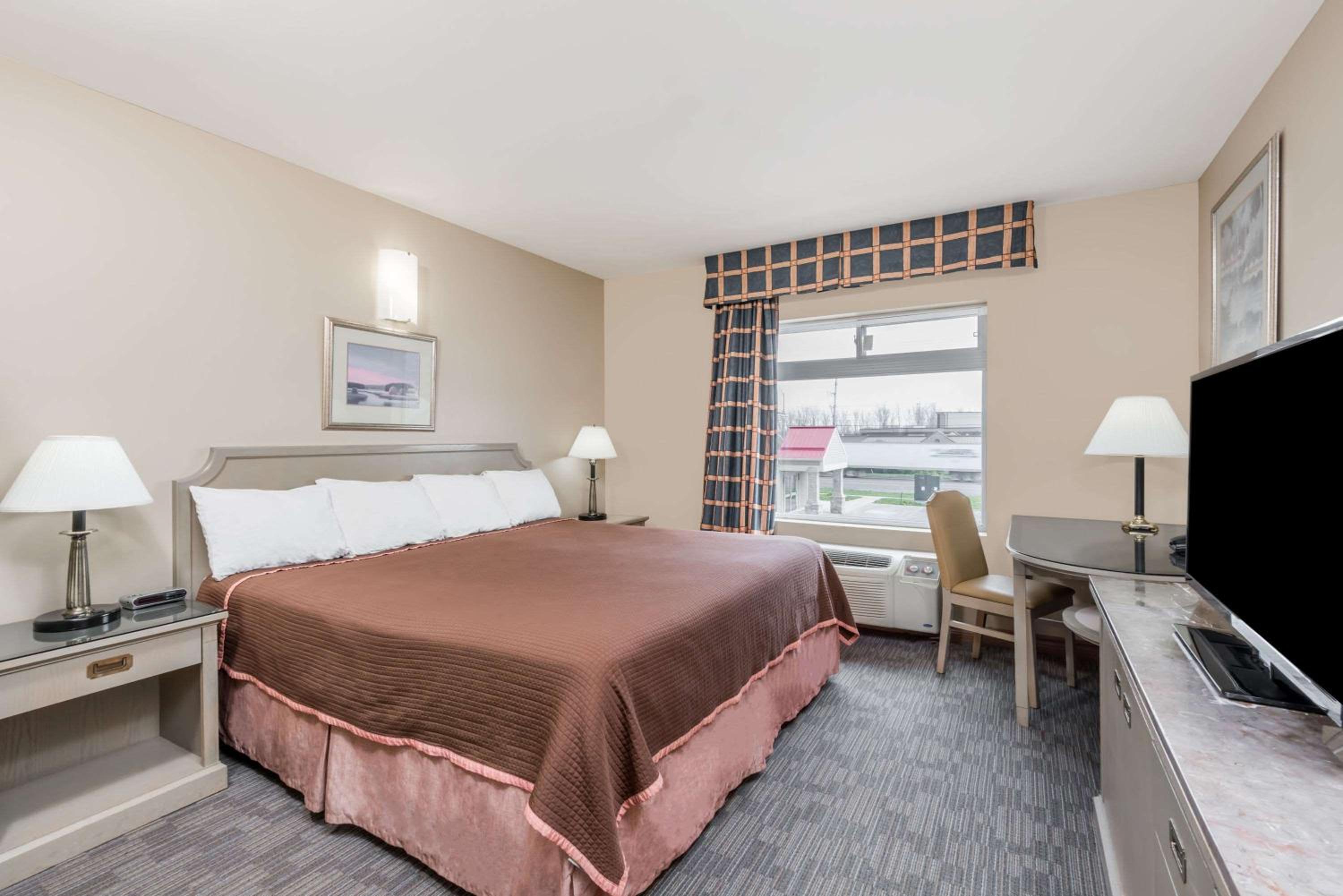 hotel room with a bed and a flat screen tv