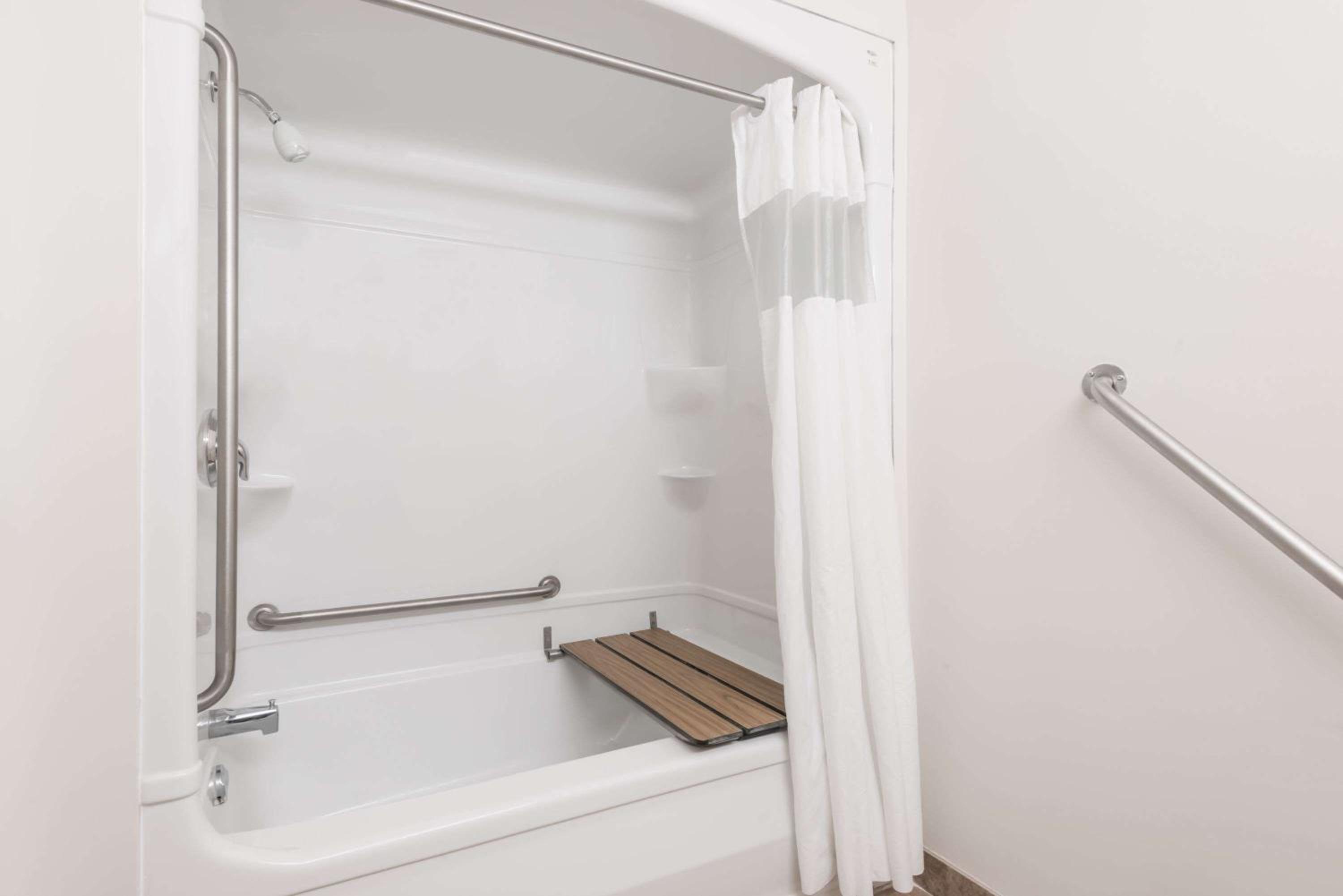 bathroom with a shower, toilet, and bathtub