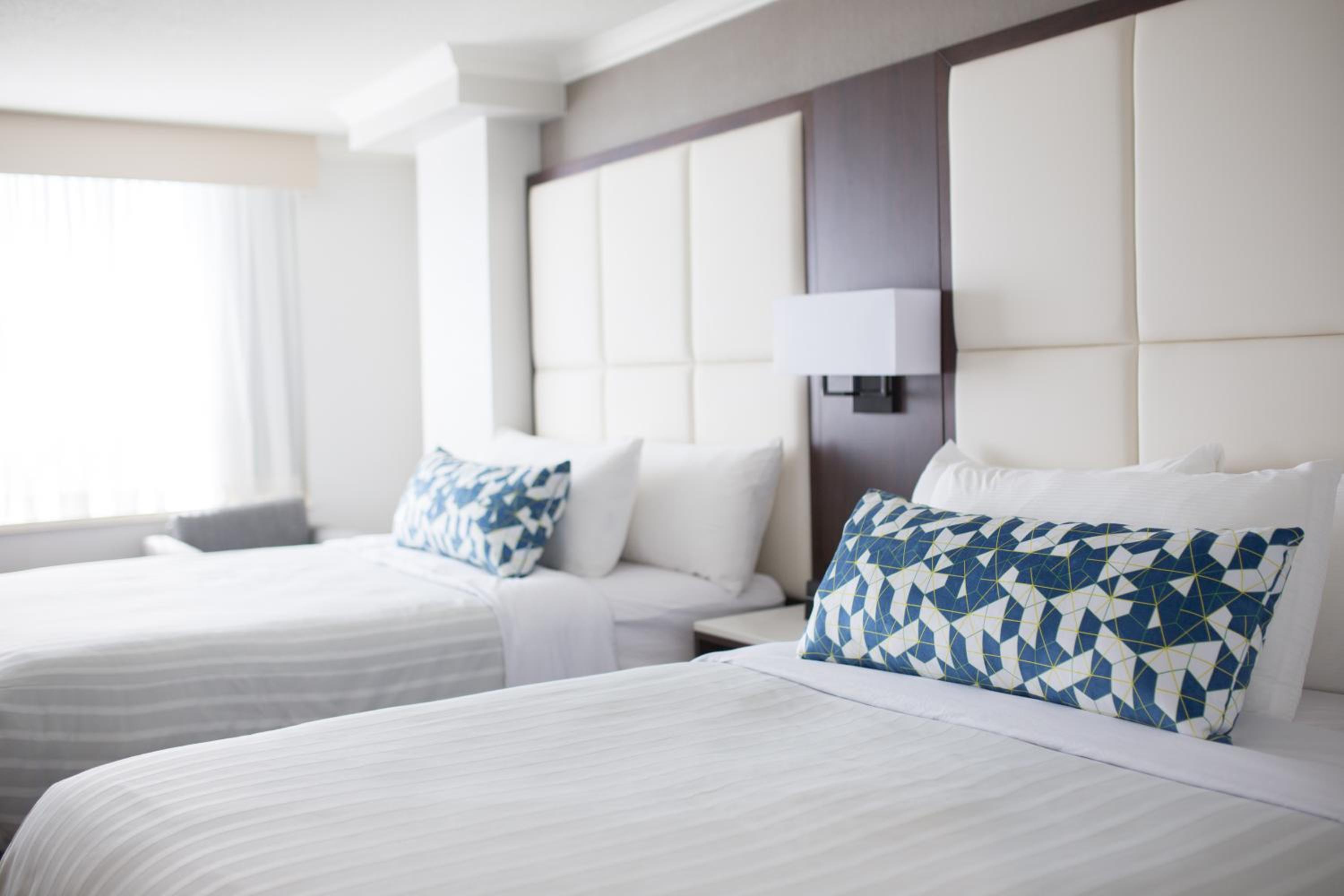 hotel room with two twin beds and a large window