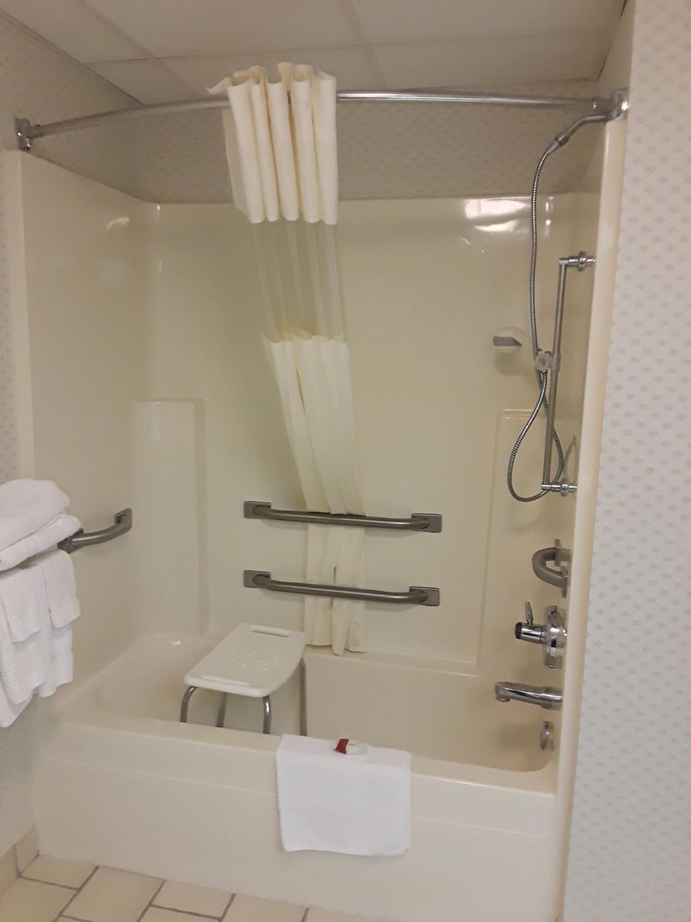 bathroom with a shower, toilet, and bathtub
