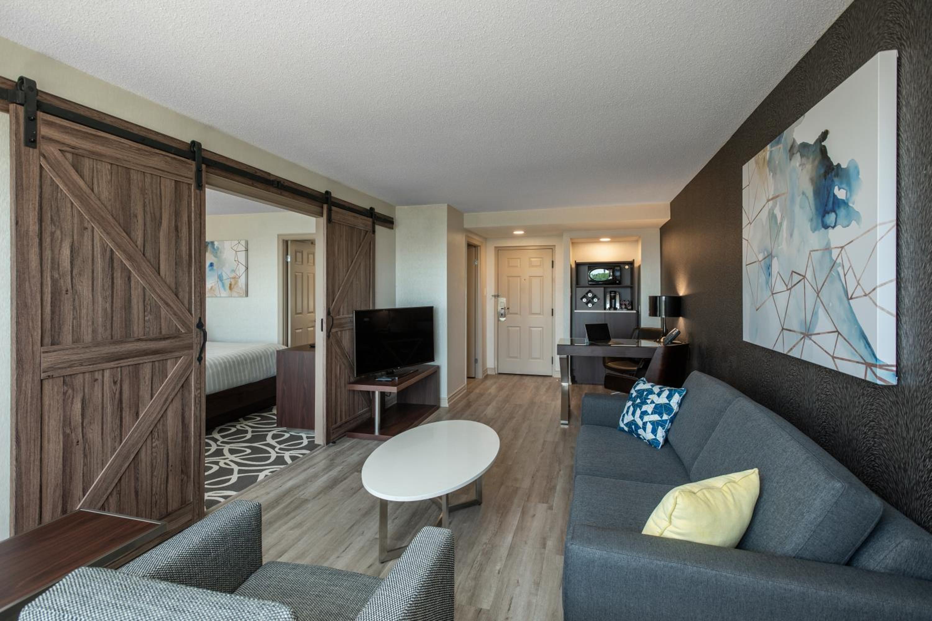living room with a couch, coffee table, and barn door