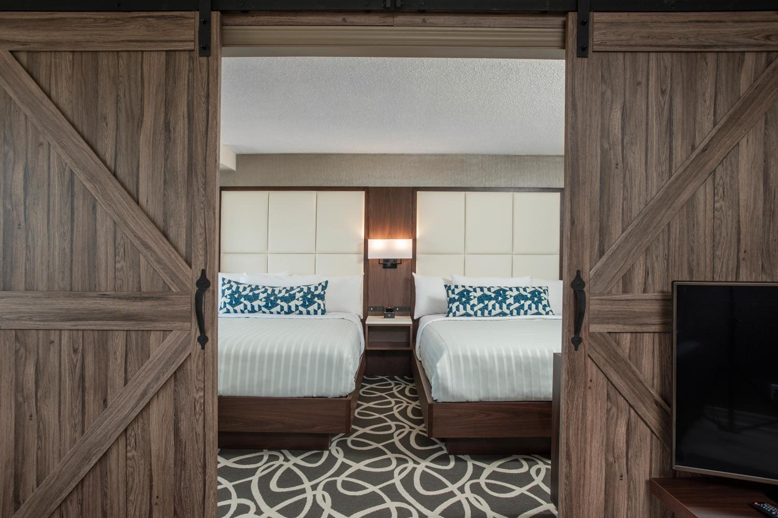 hotel room with two beds and a flat screen tv