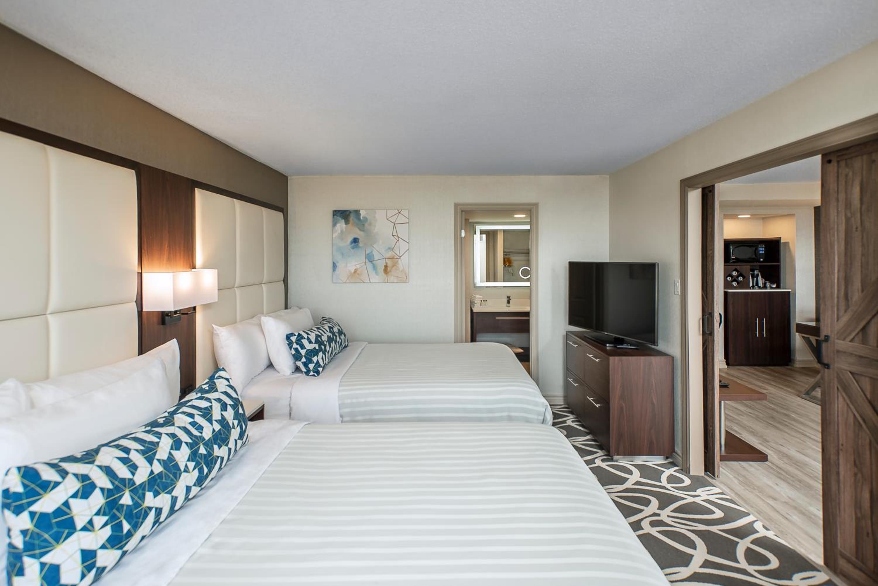 hotel room with two beds and a flat screen tv