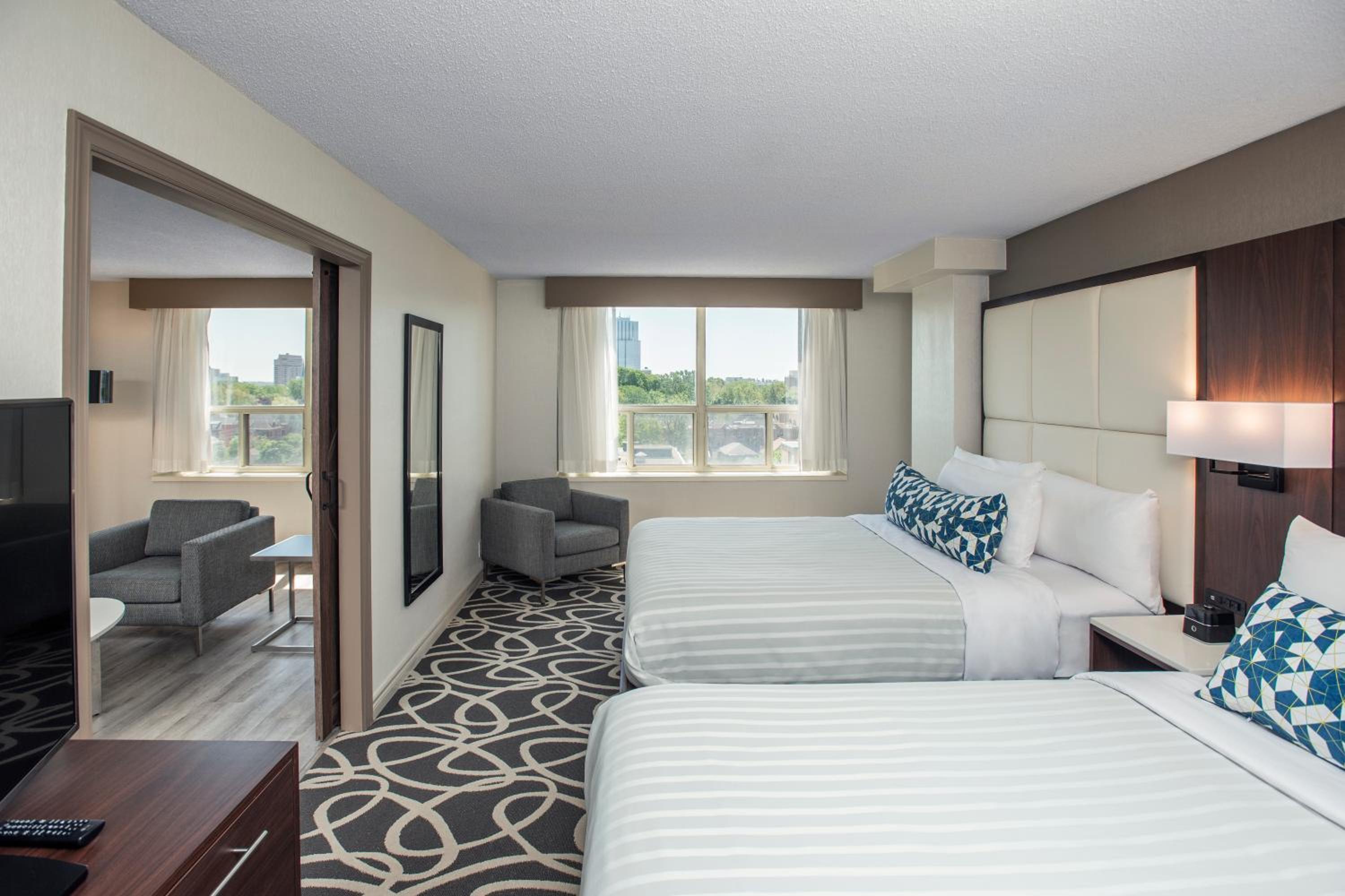 hotel room with two beds and a flat screen tv