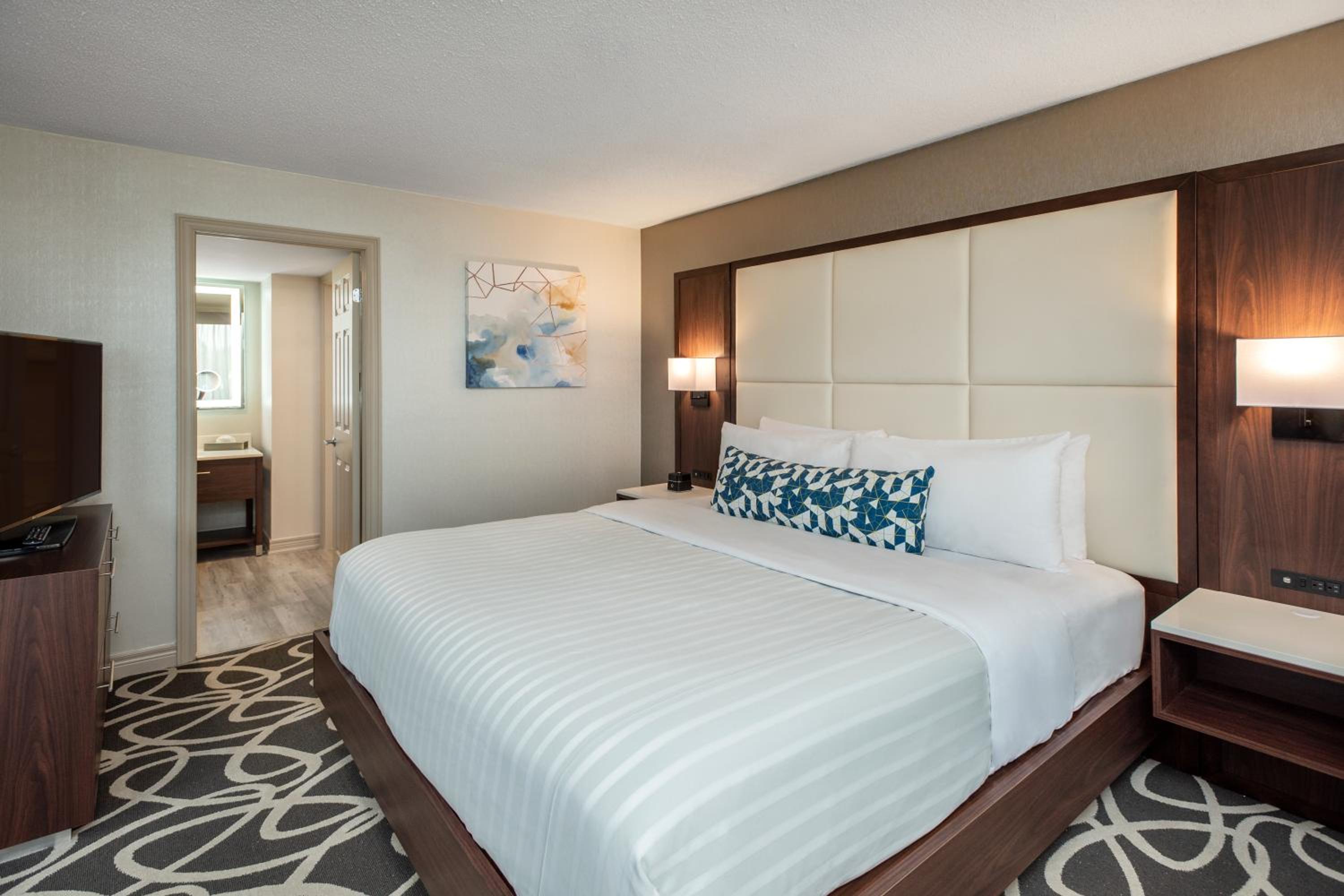 hotel room with a large bed and a flat screen tv