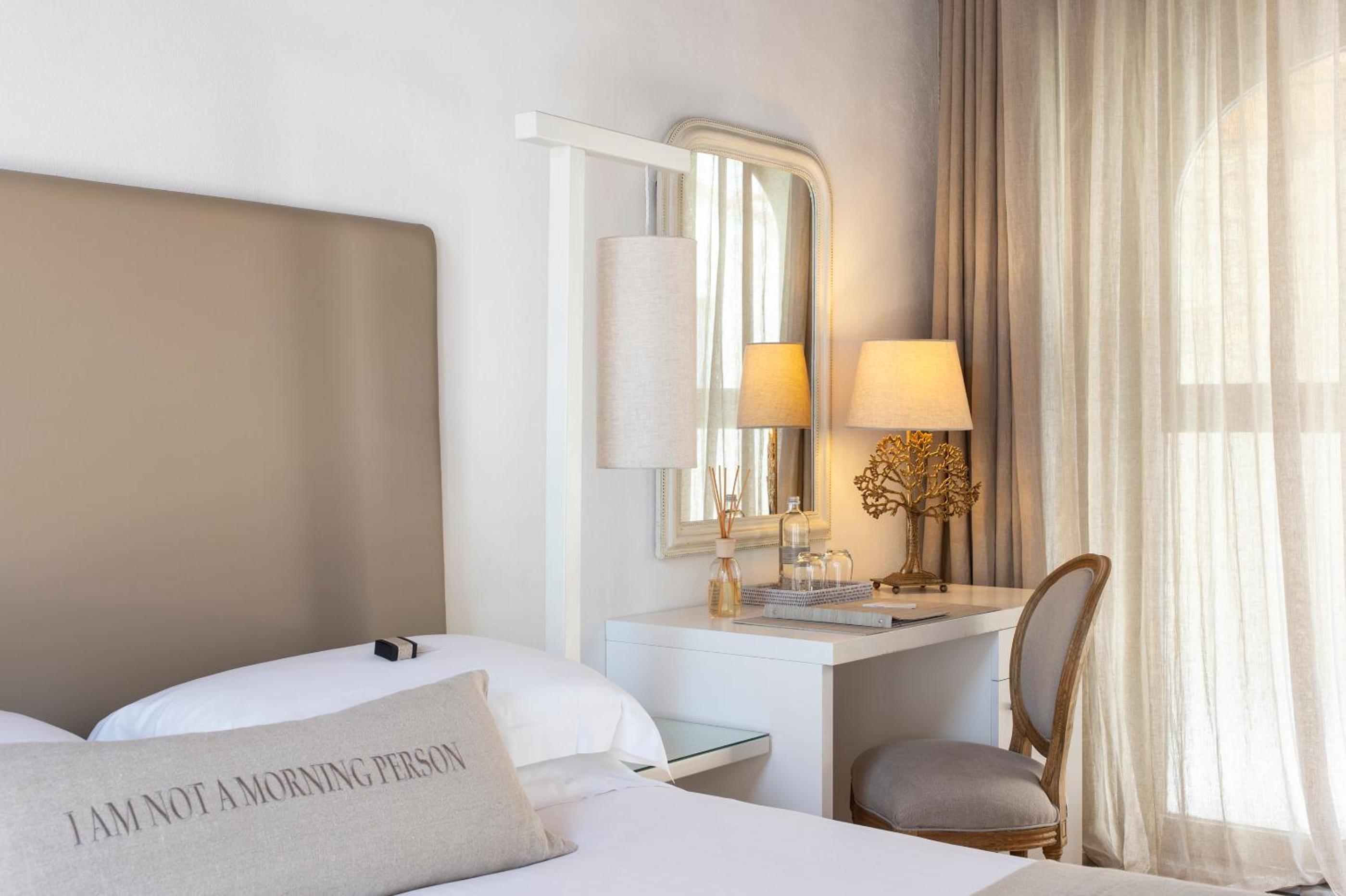 hotel room with a bed, desk, and chair
