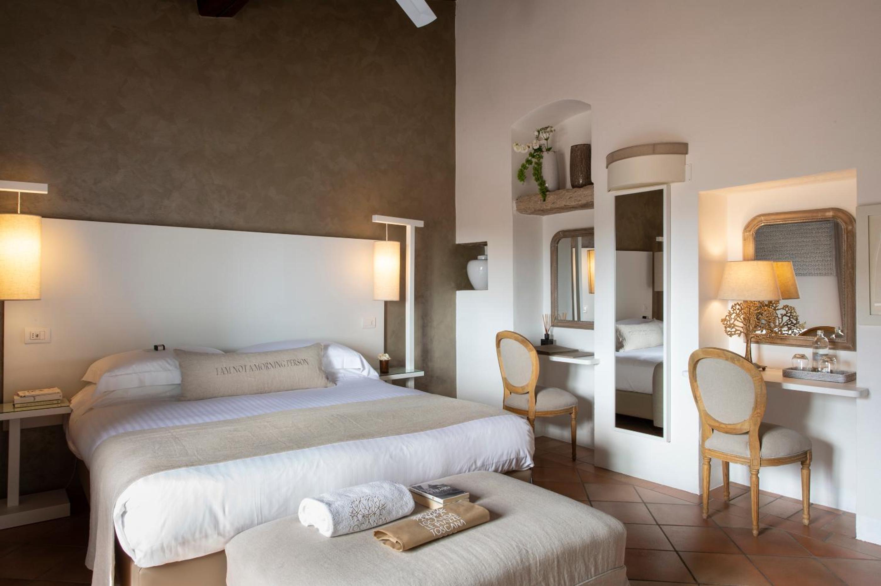 hotel room with two beds and a desk in the corner