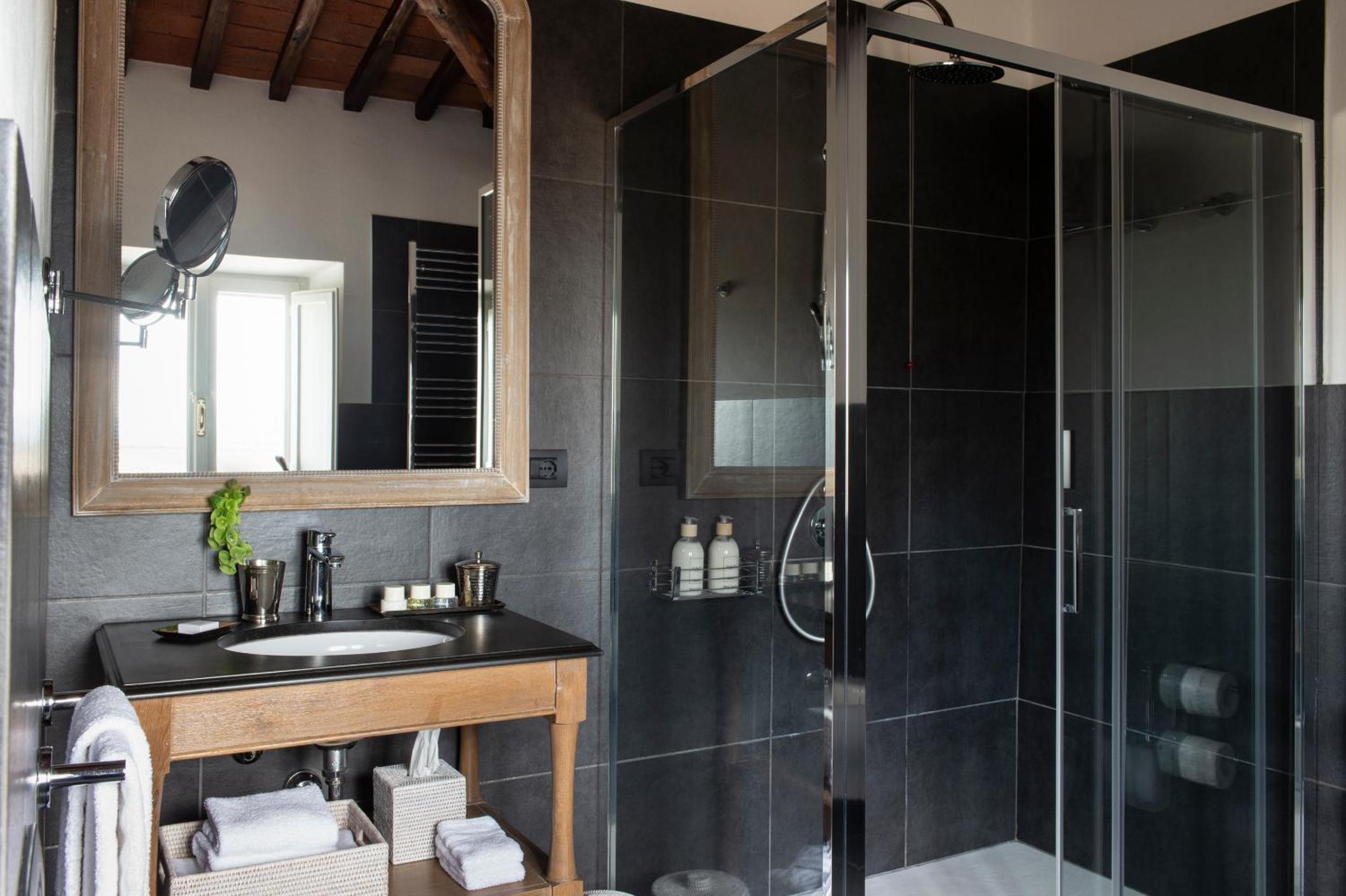 black and white bathroom with a walk - in shower