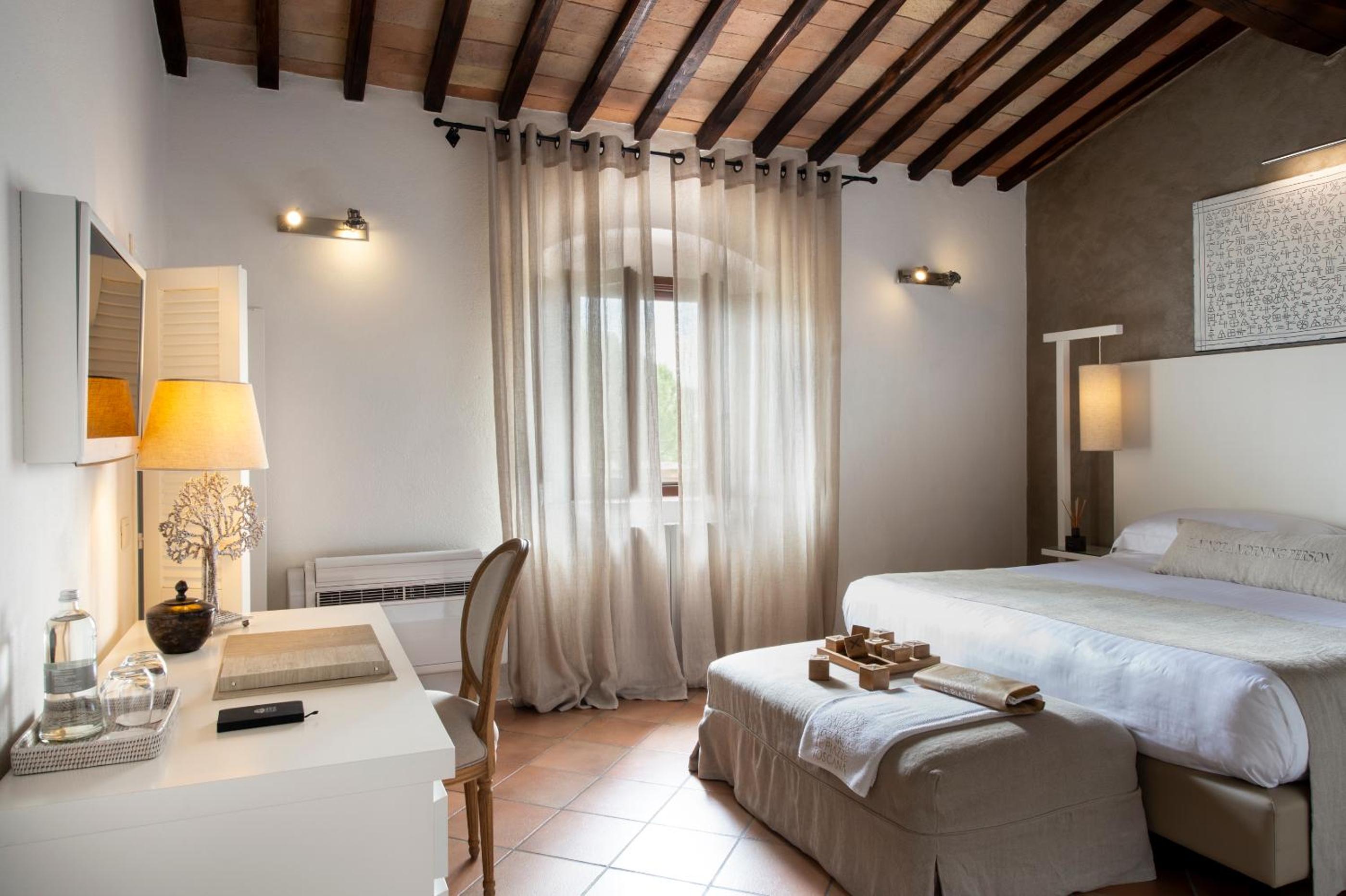 hotel room with a bed, desk, and chair