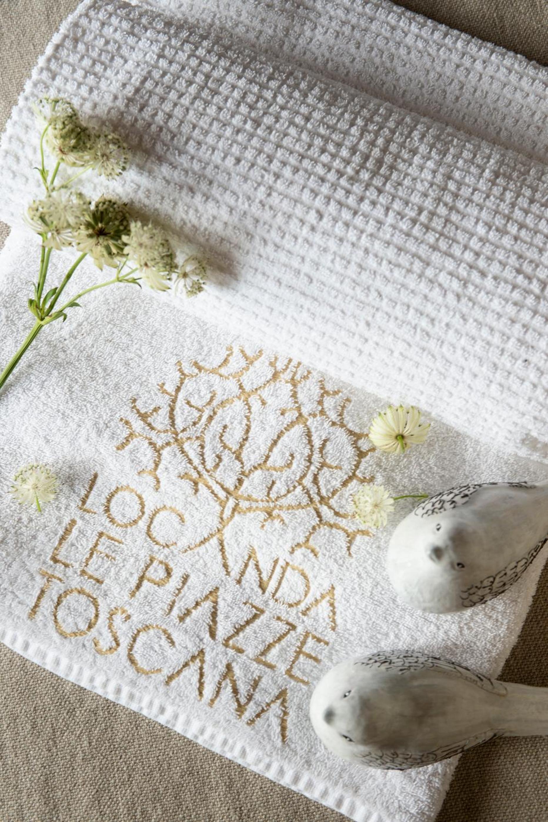 white towel with the words bona bona written on it