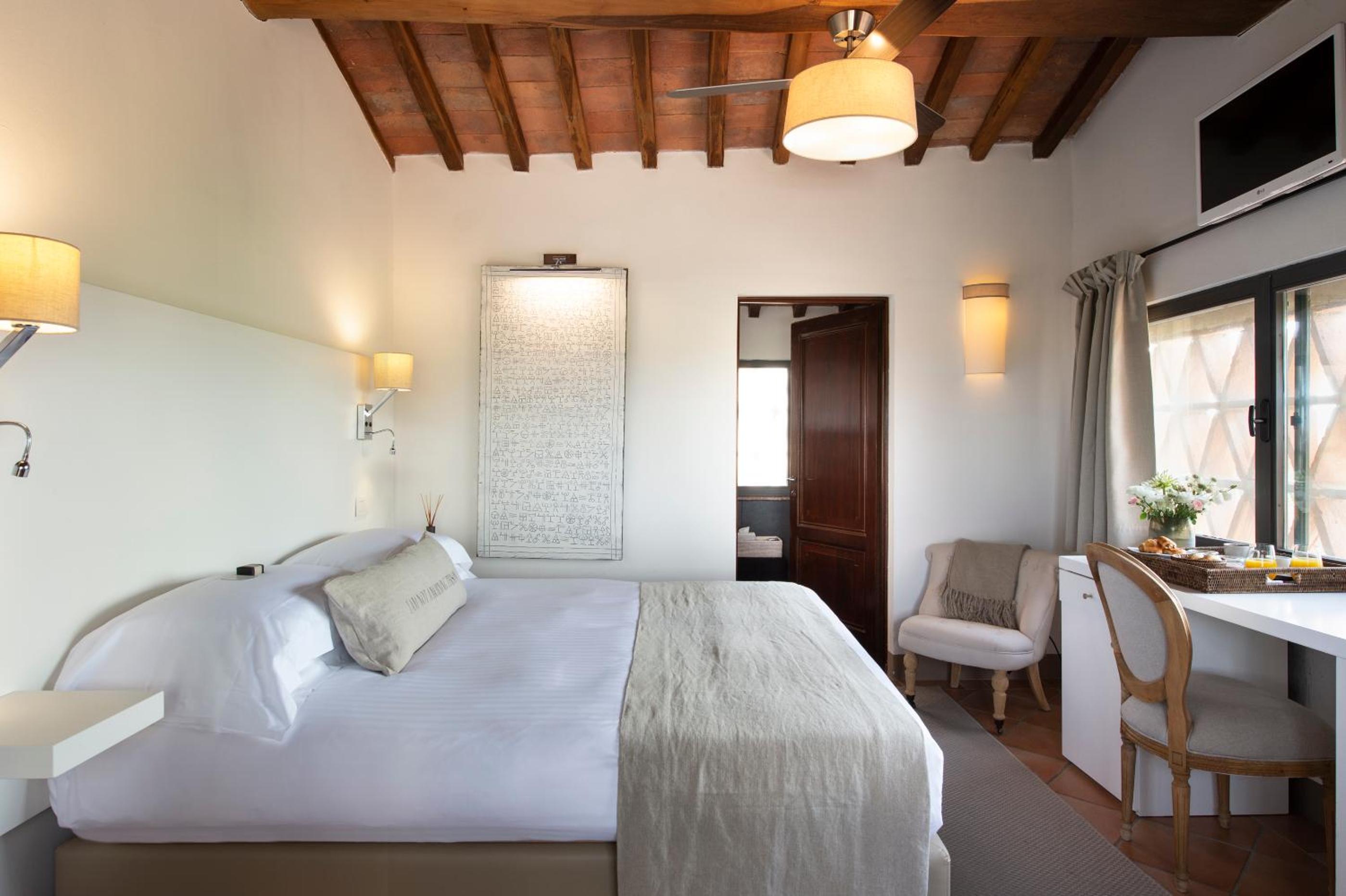 hotel room with a bed, desk, and chair