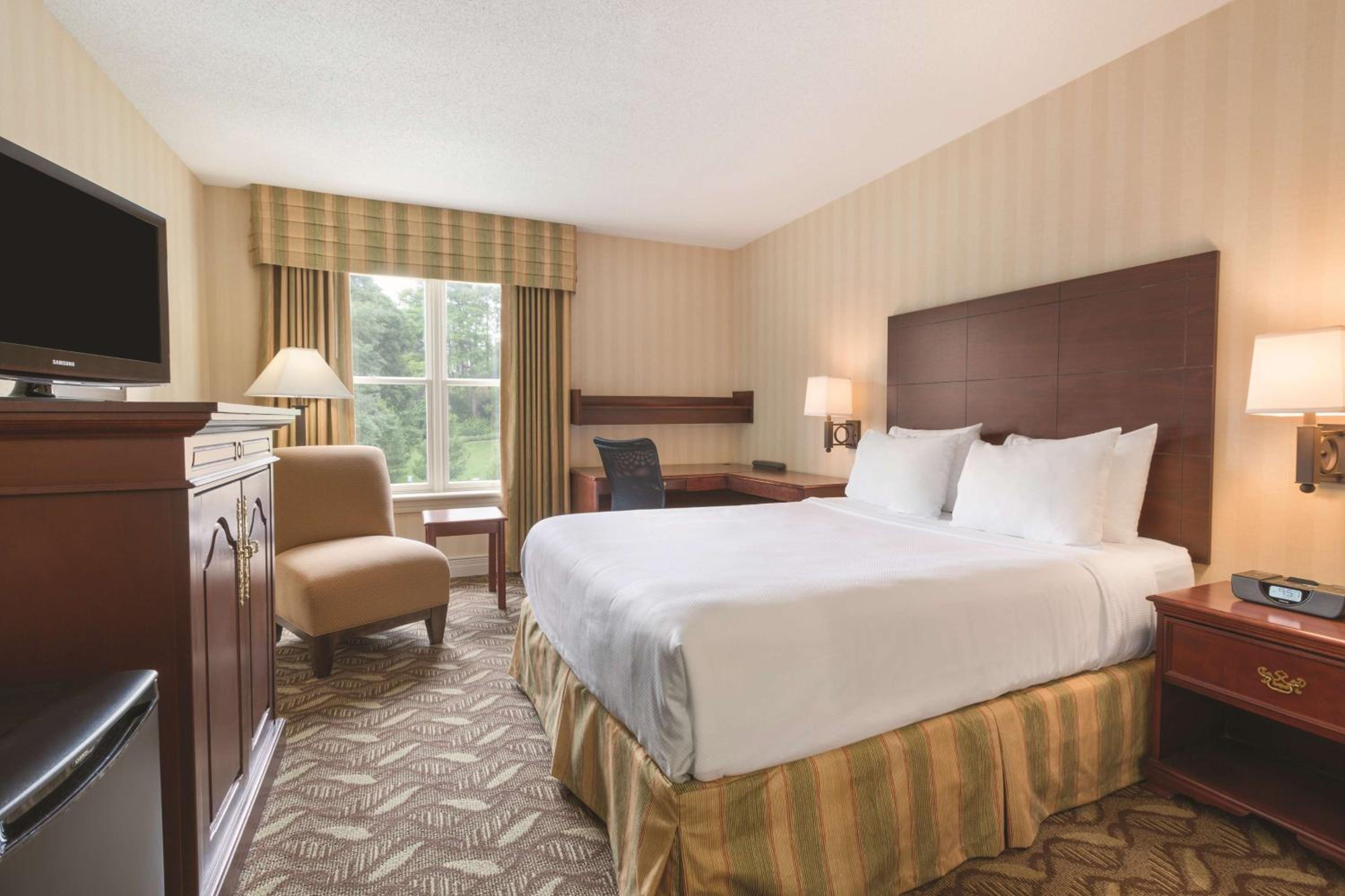 hotel room with a king size bed and flat screen tv