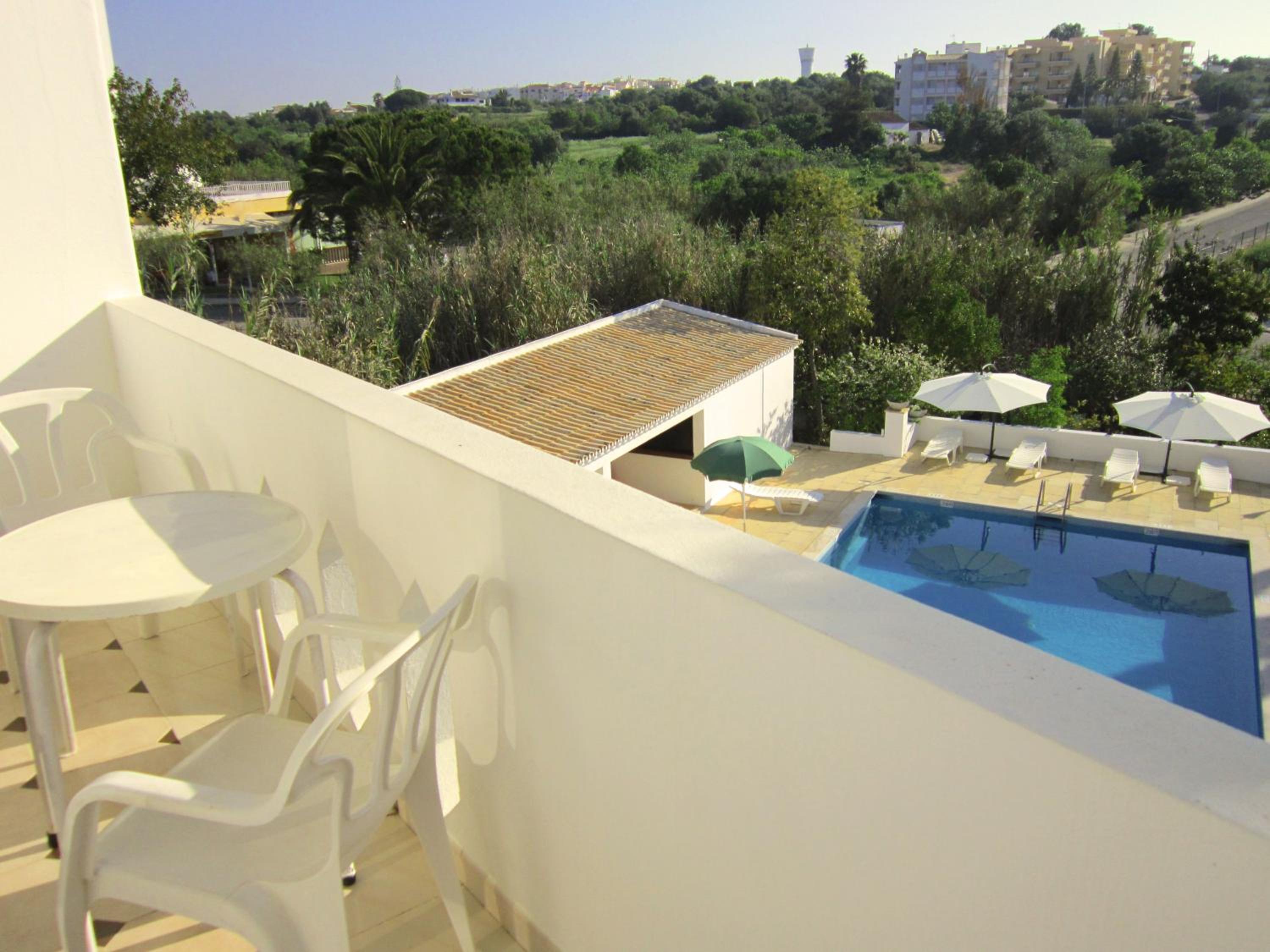 Family Room with Balcony and Pool View photo 2