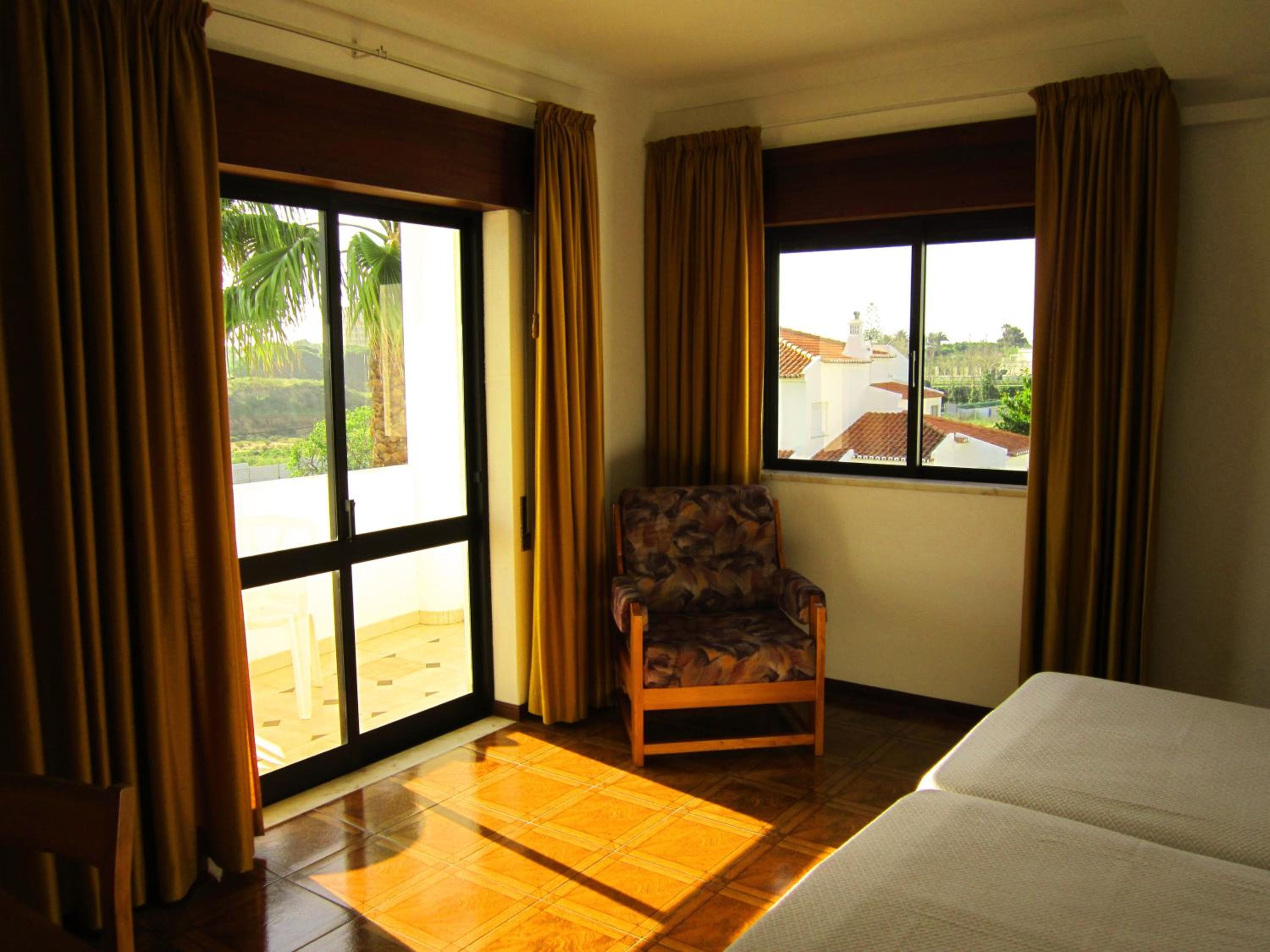 Family Room with Balcony and Pool View photo 1