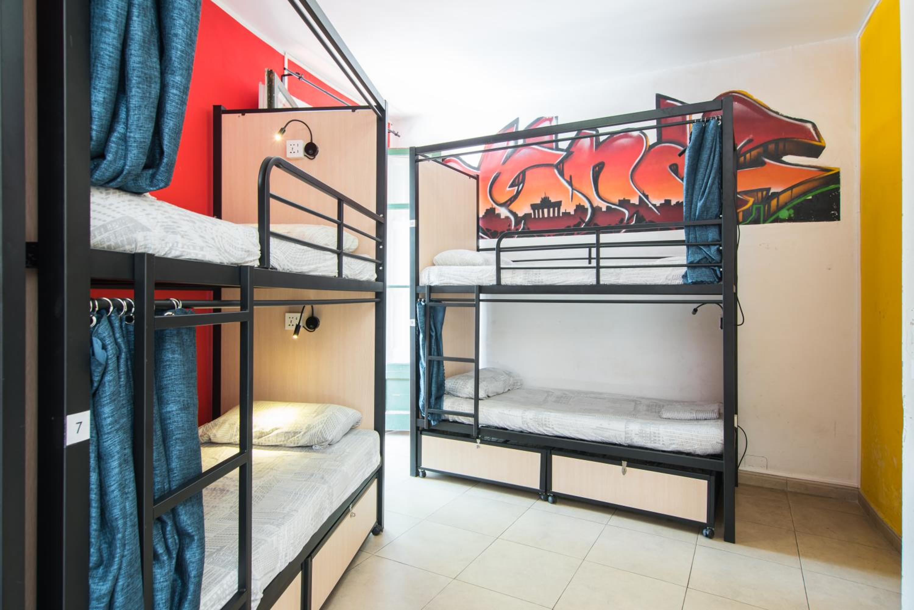 Cama en habitación compartida de 12 camas para mujeres con baño privado.
