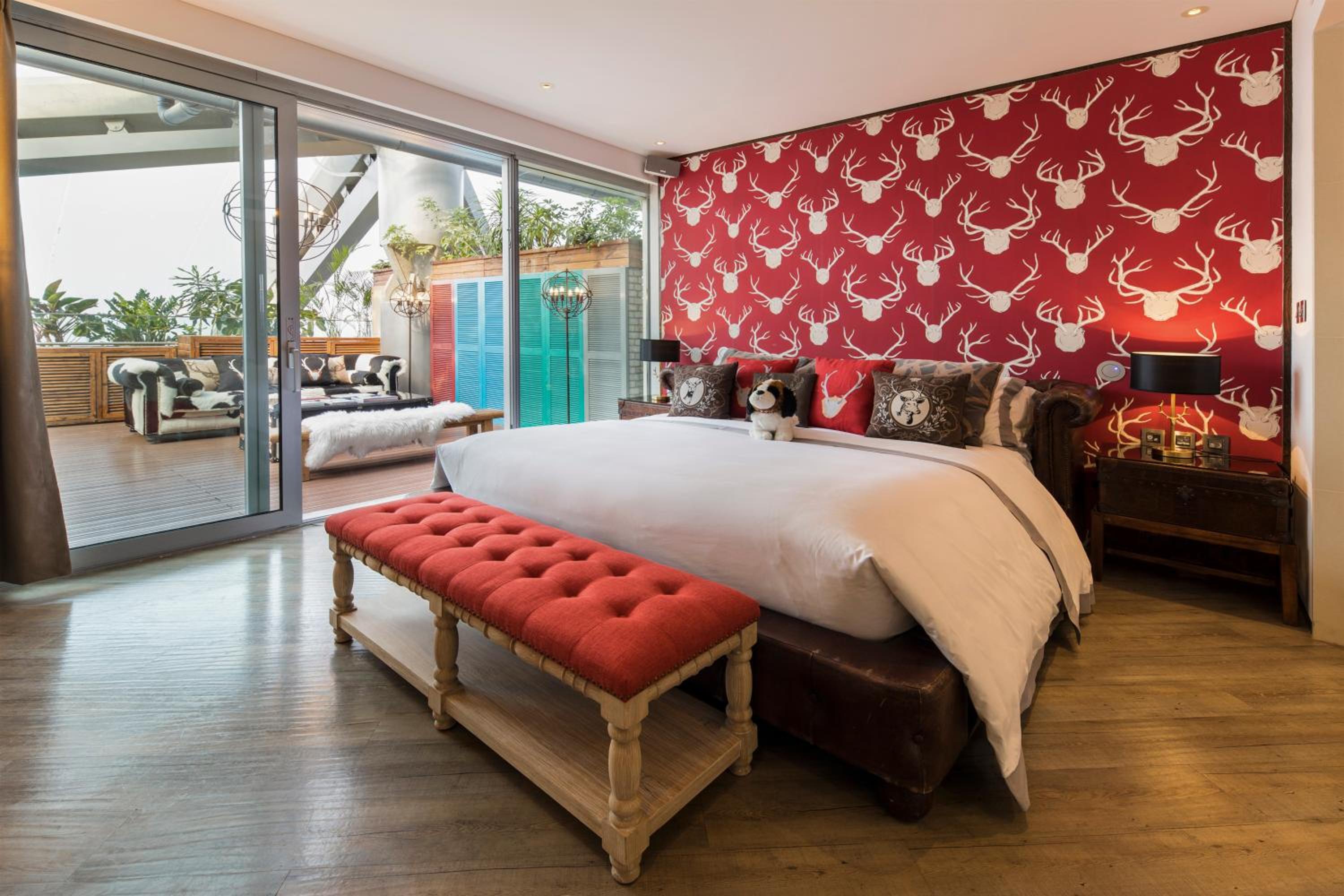 bedroom with a large bed and red wallpapered walls