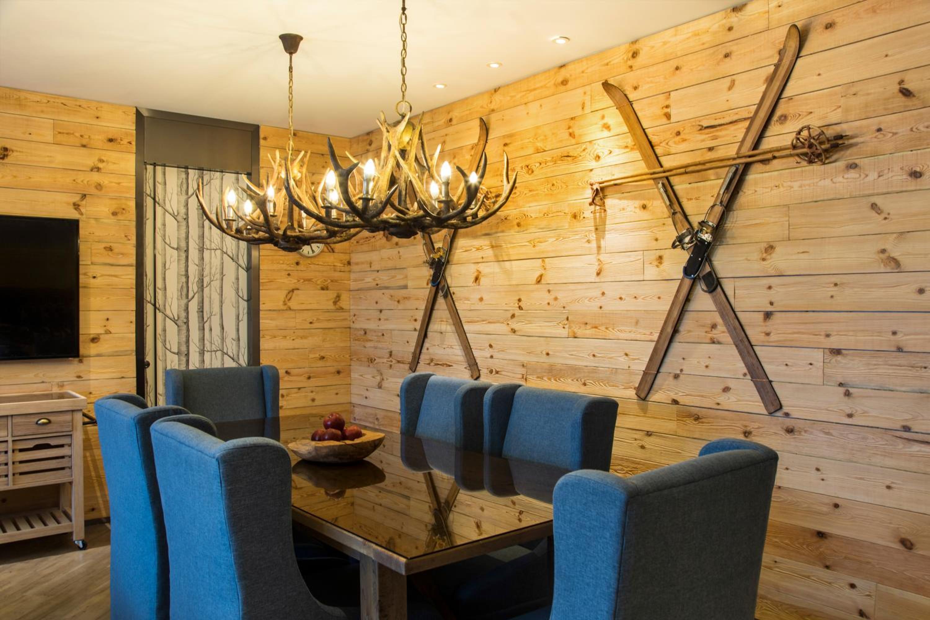 dining room table and chairs with antlers on the wall