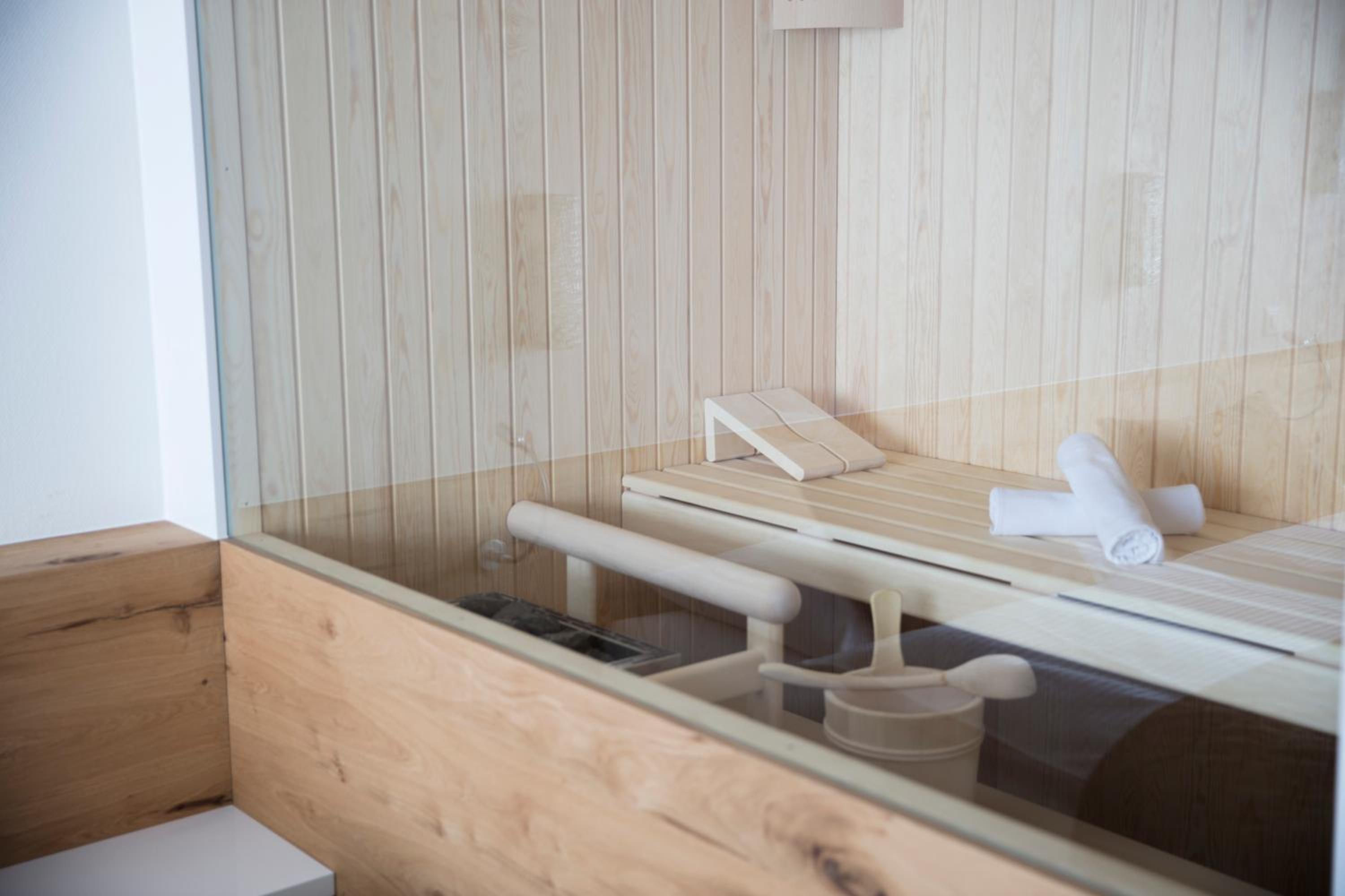 sauna room with wooden walls and wood flooring
