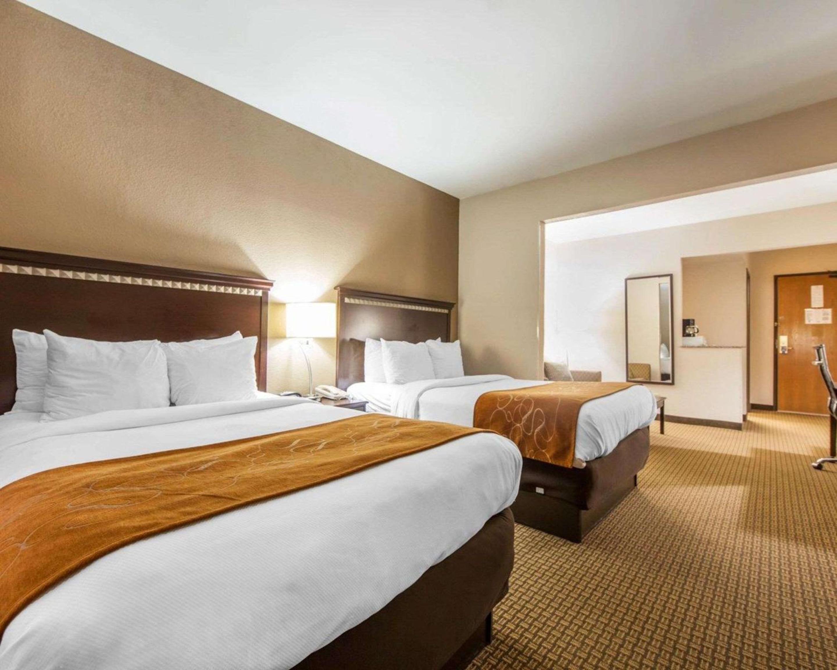 hotel room with two queen beds and a flat screen tv