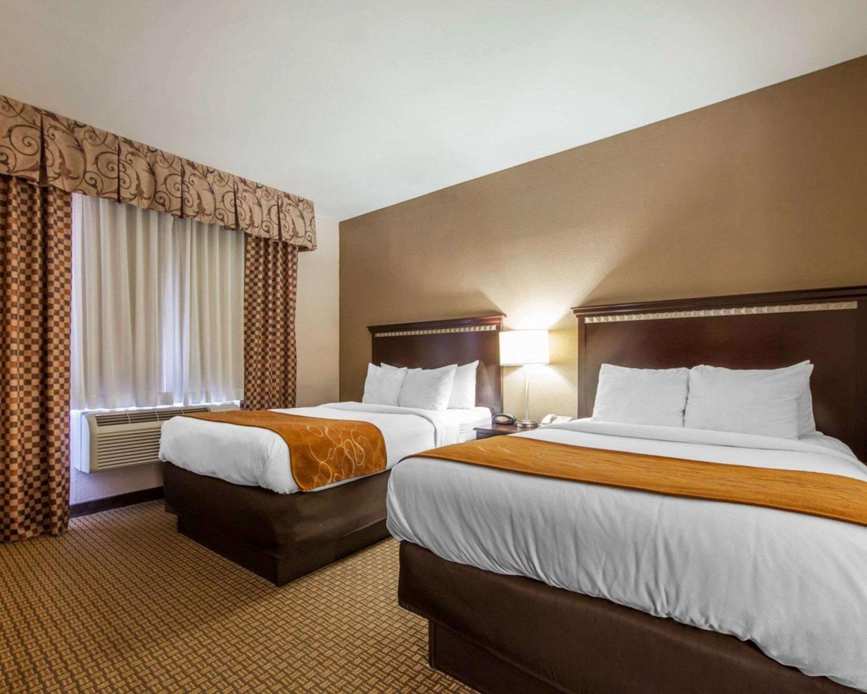 hotel room with two beds and a flat screen tv