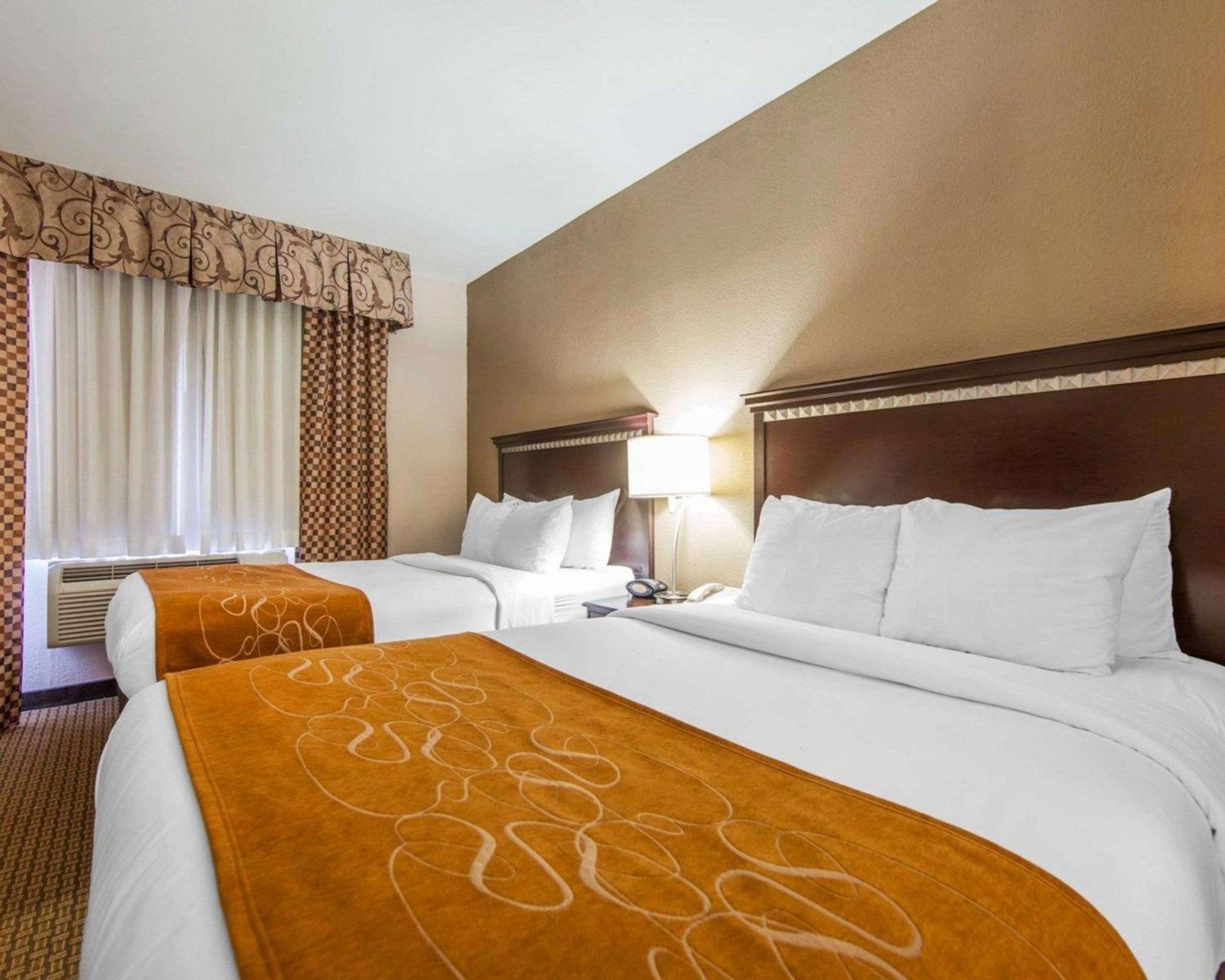 hotel room with two beds and a flat screen tv