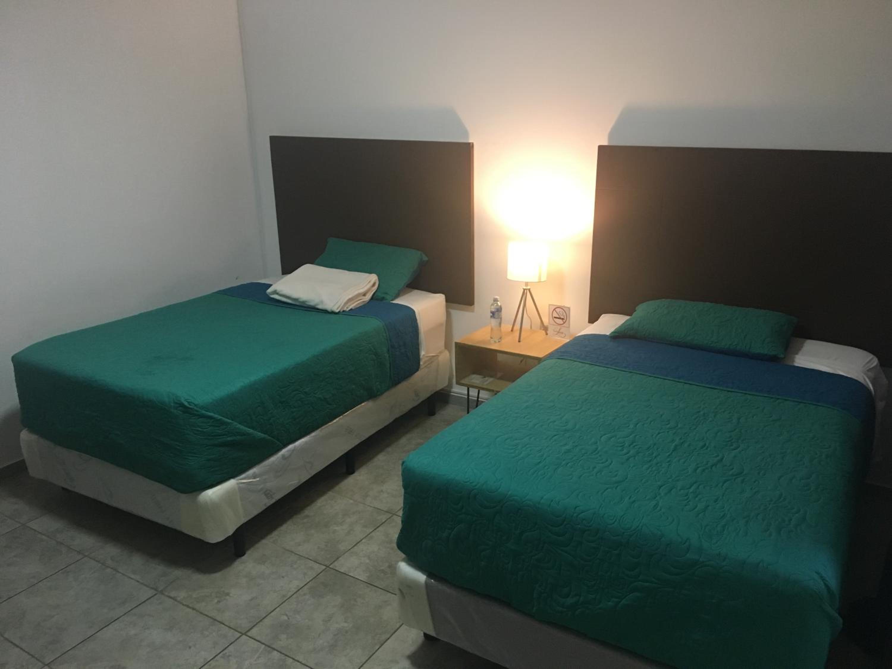 Habitación Deluxe Queen con Dos Camas Queen