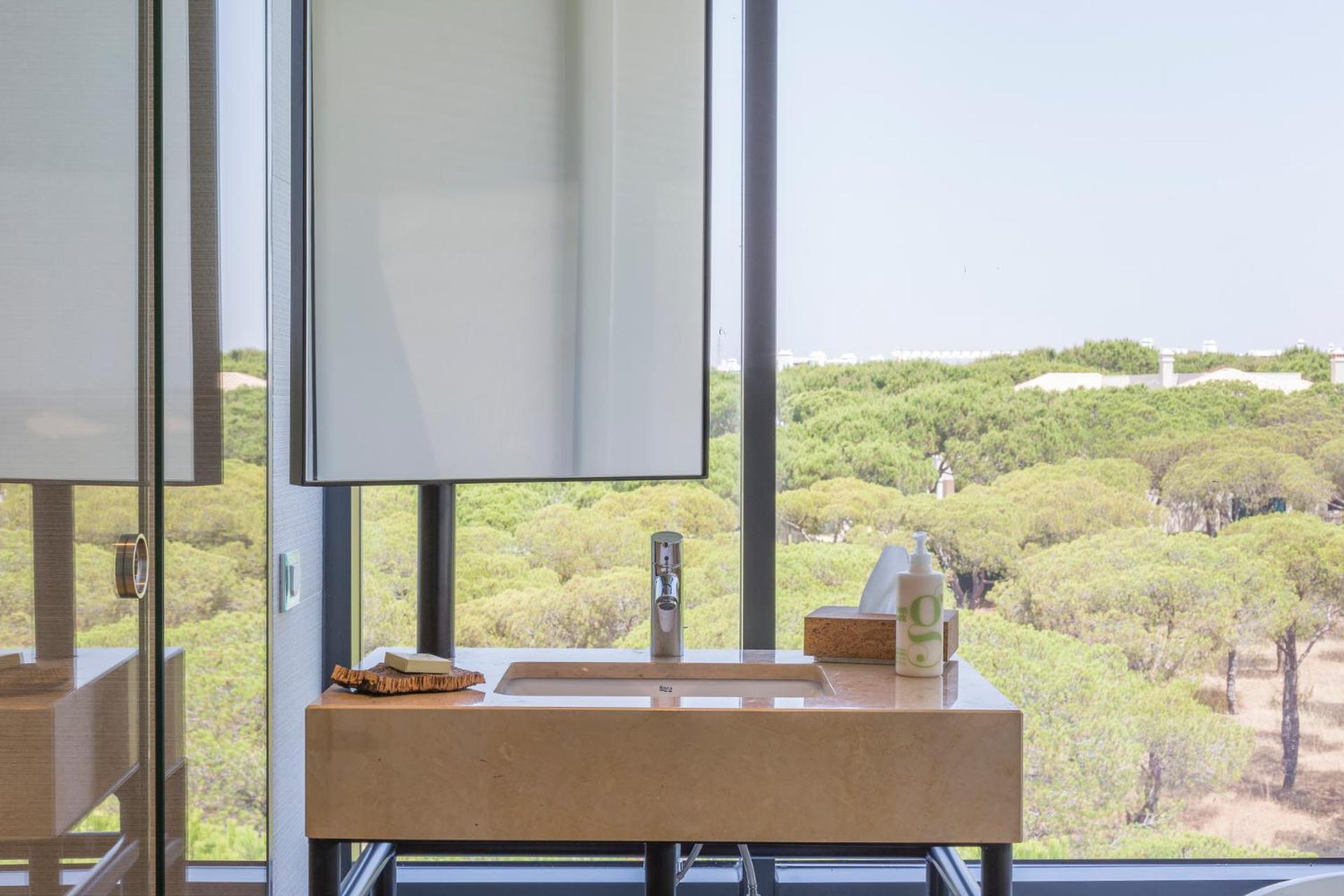 modern bathroom with a view of the trees outside?