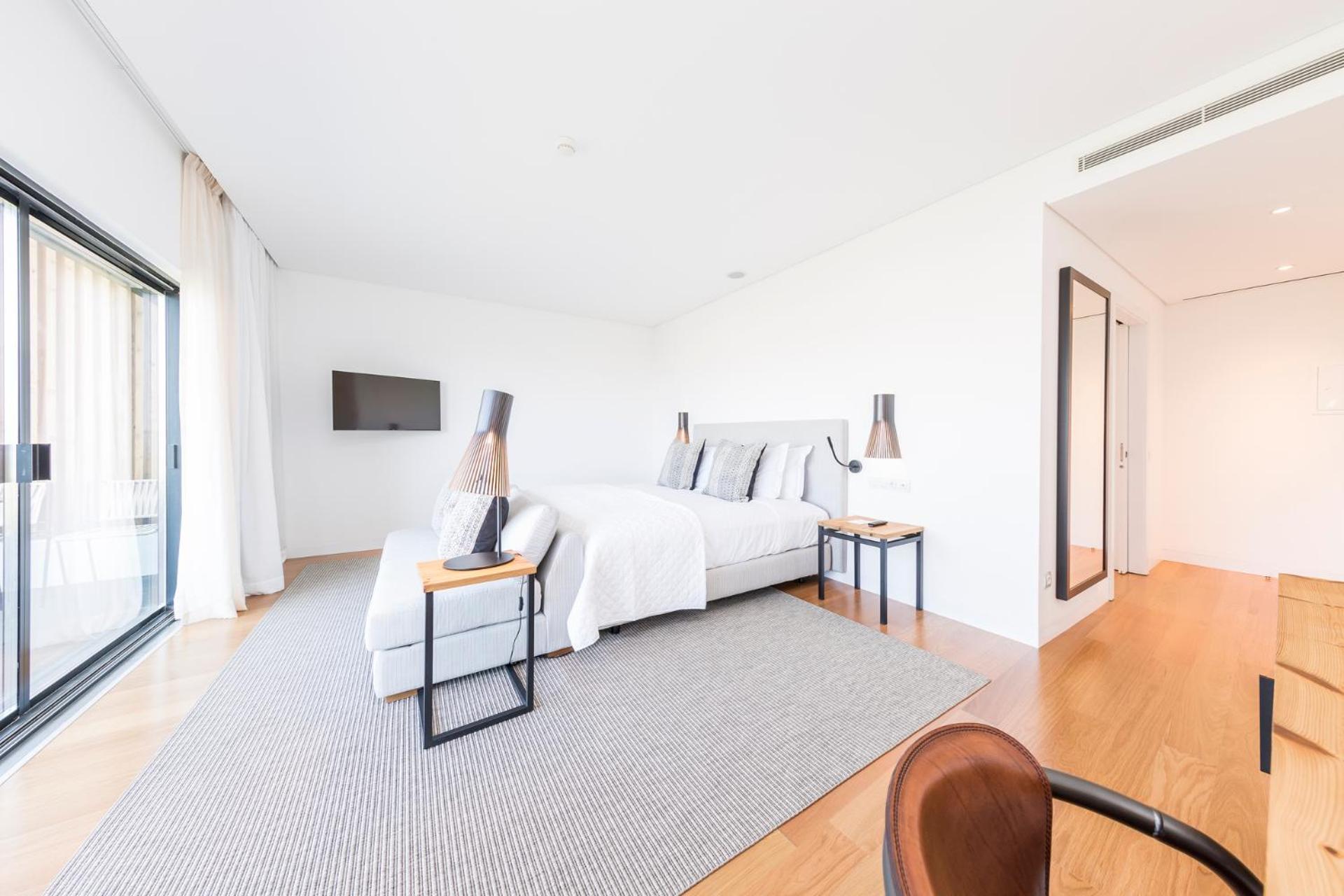 bedroom with a large bed and a sliding glass door