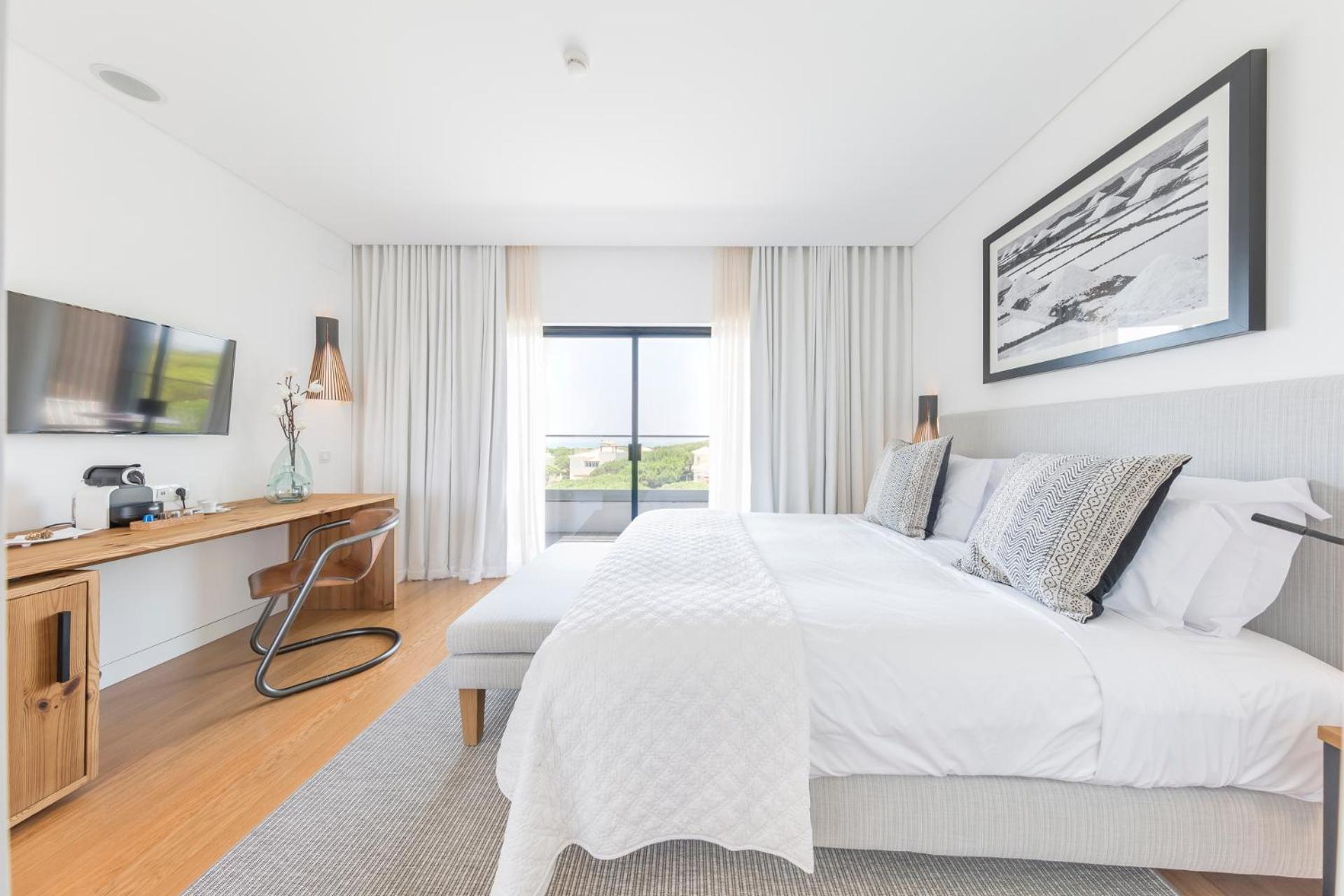 bedroom with a large bed and a flat screen tv