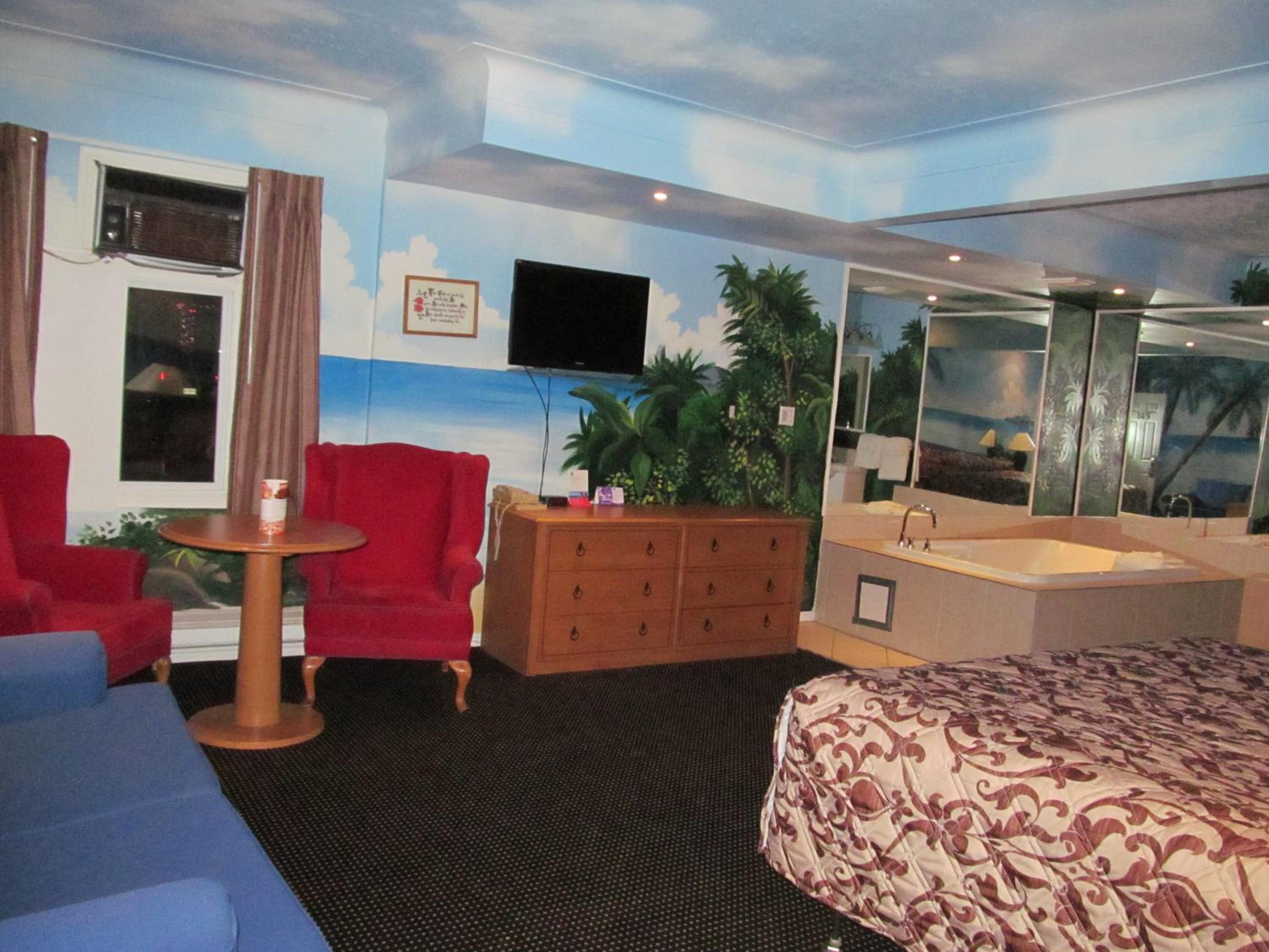 hotel room with a jacuzzi tub in the corner