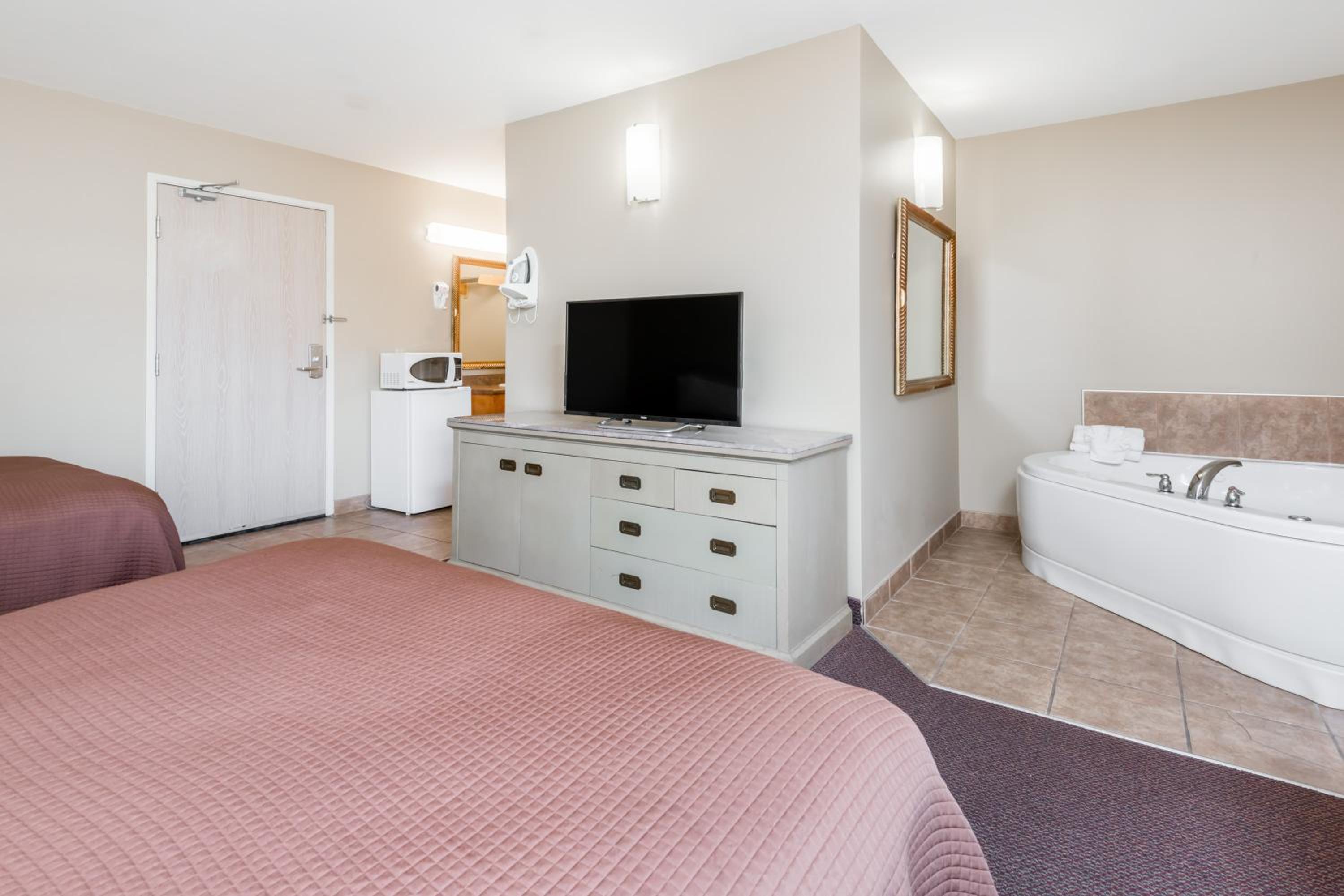 hotel room with two beds and a flat screen tv
