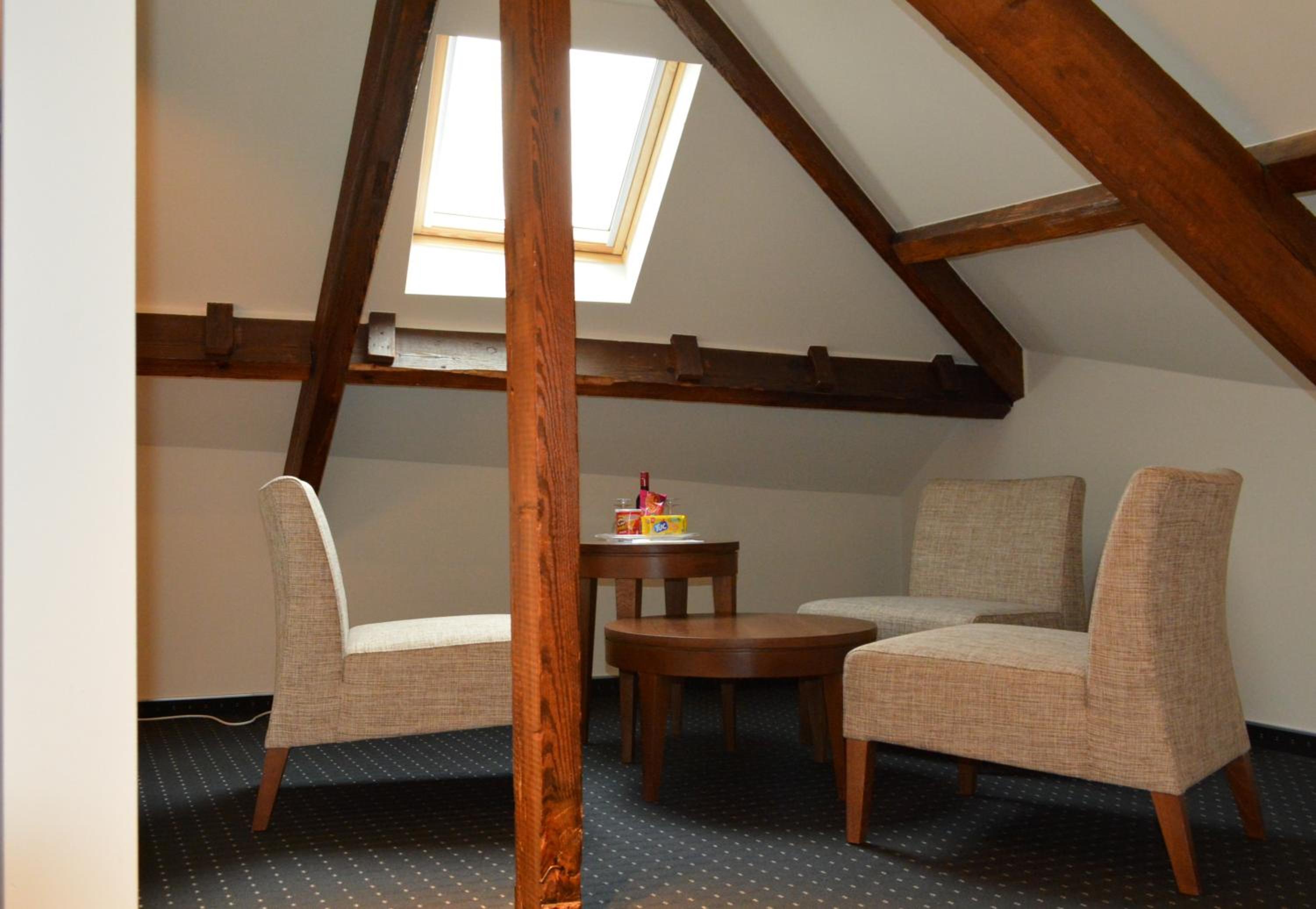 lofted room with two chairs and a small table