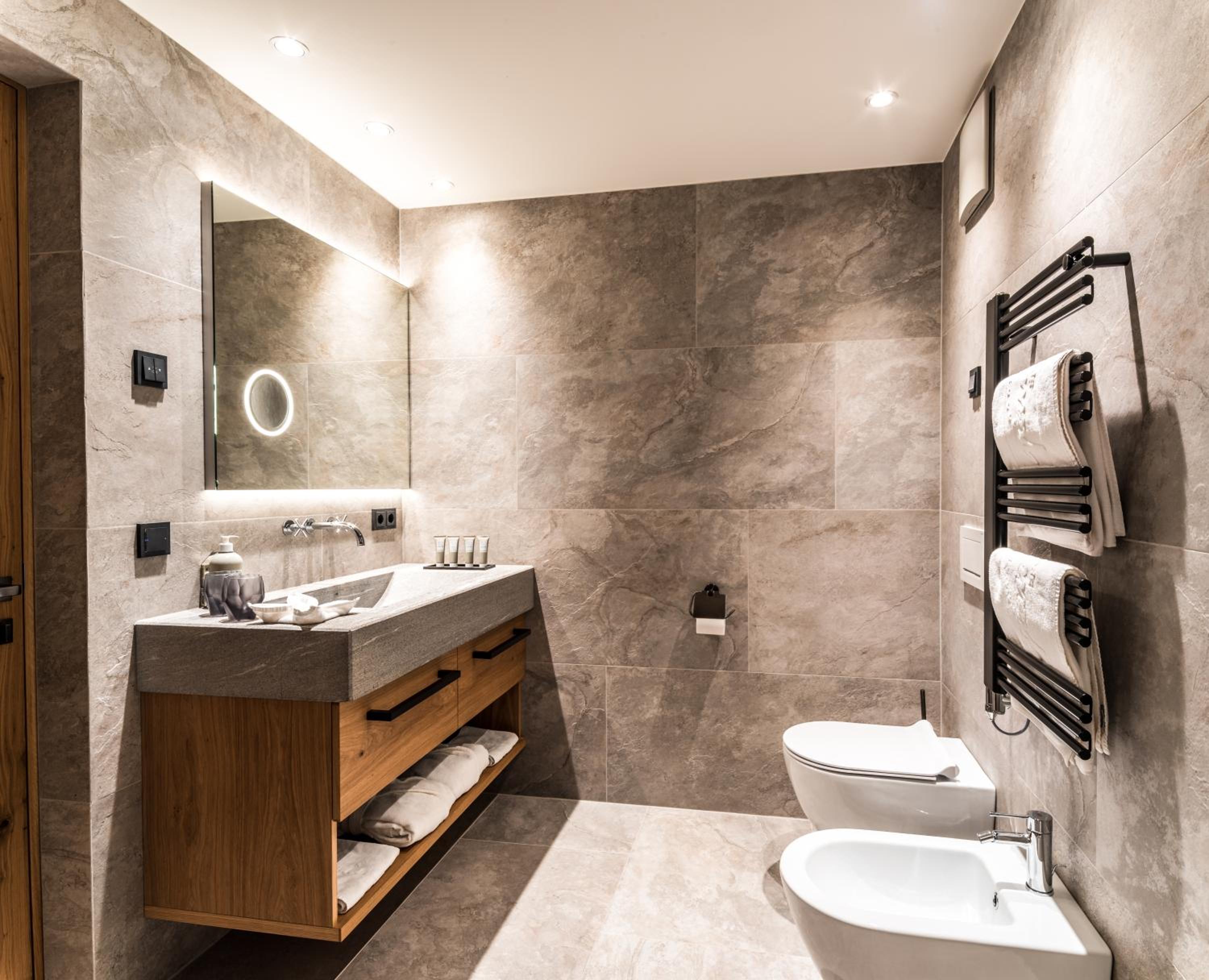 bathroom with a sink, toilet, and bidet