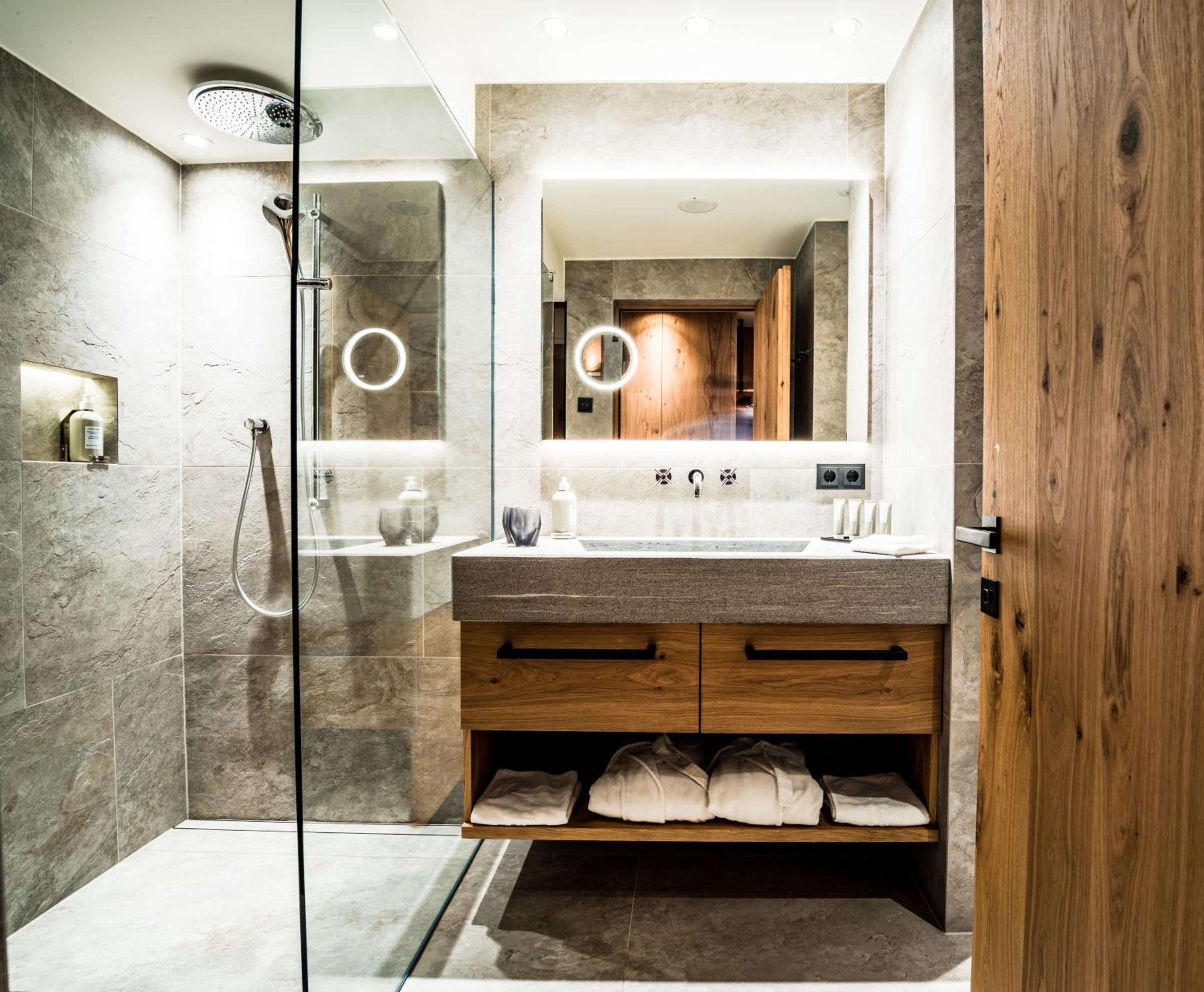 bathroom with a walk - in shower and double sinks