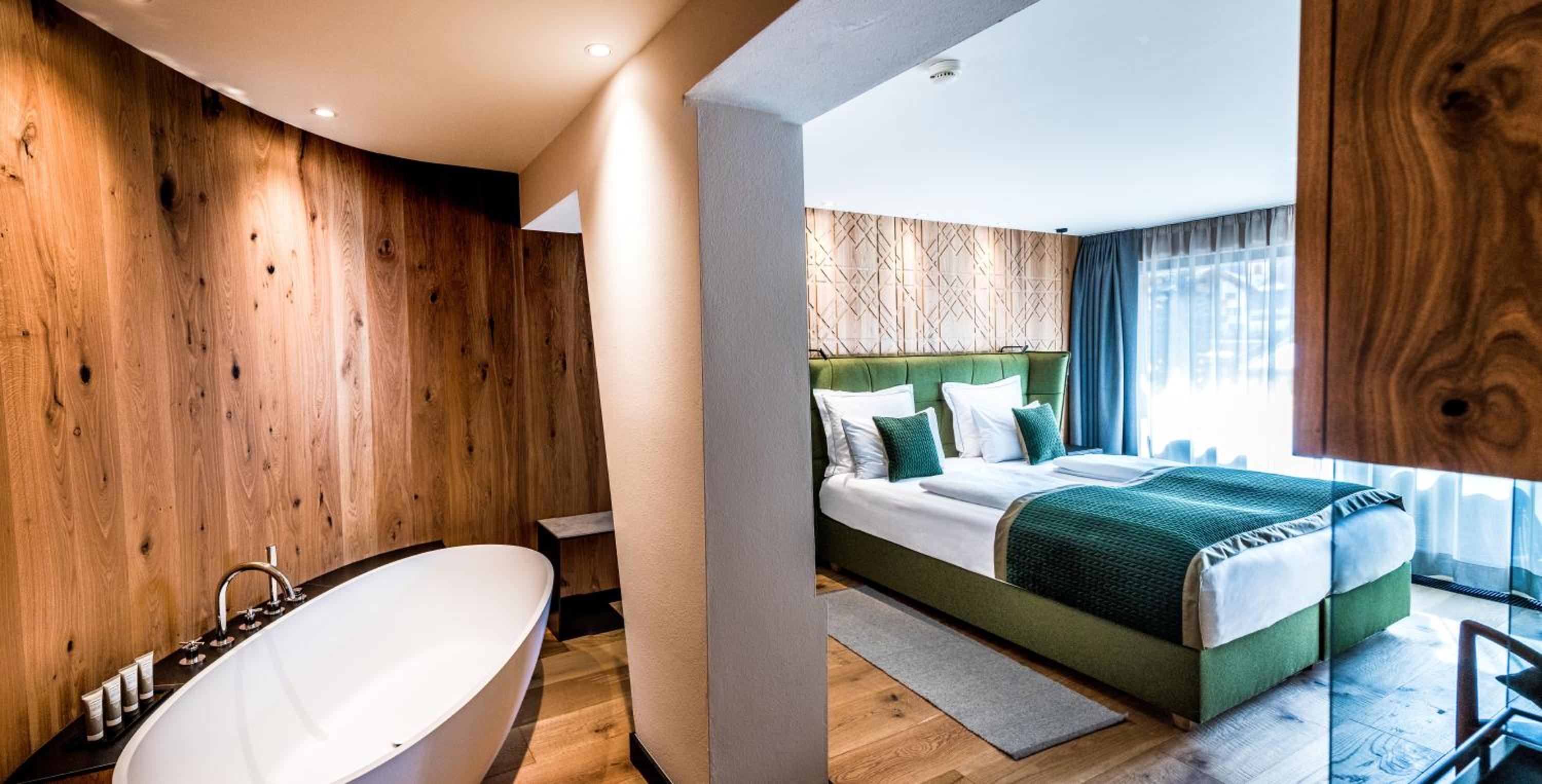 room with a bed and a bathtub in it