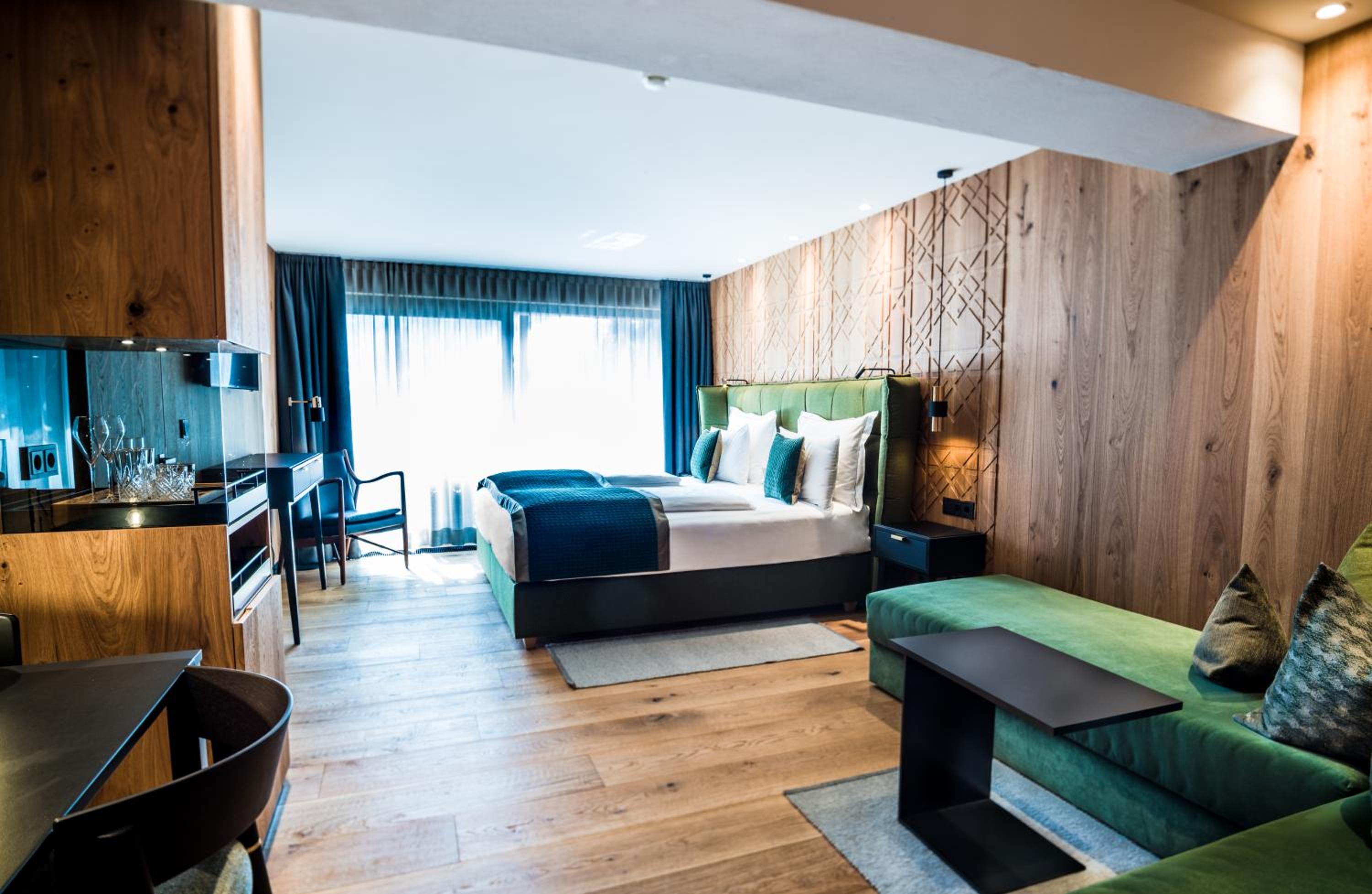 hotel room with wood paneling and a green couch