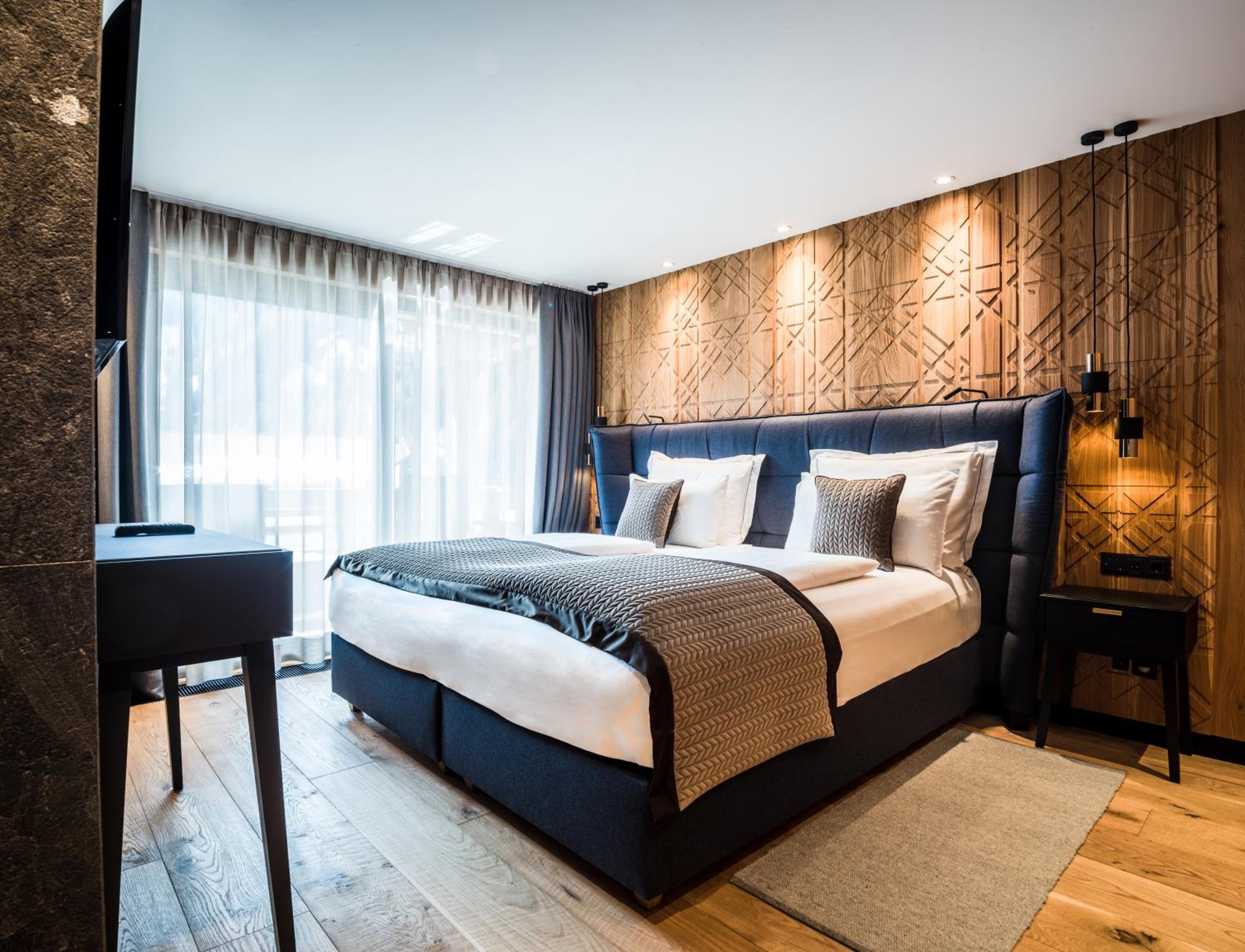 hotel room with wood paneling and a large bed