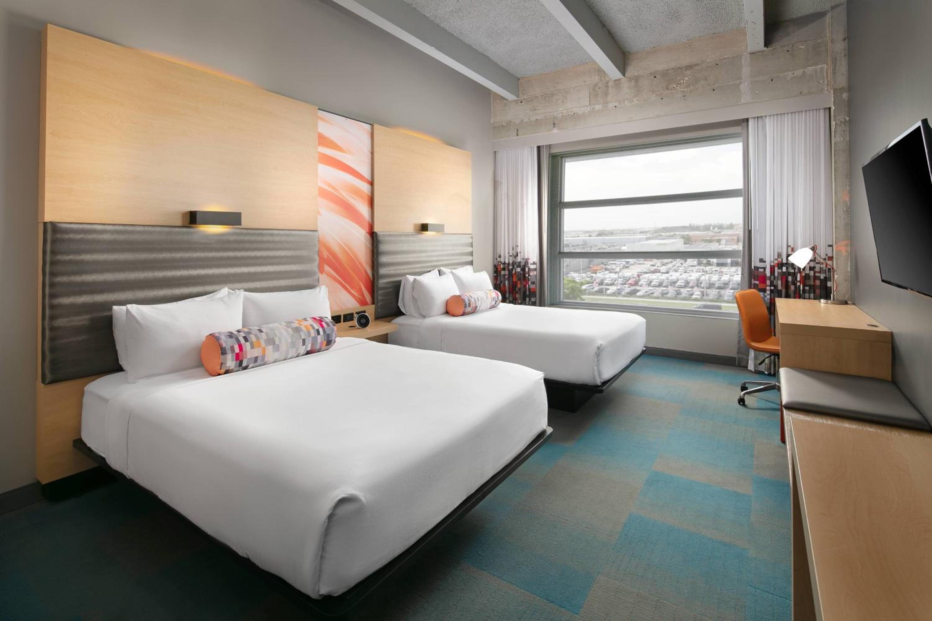 Larger Queen Room with Two Queen Beds and Pool View